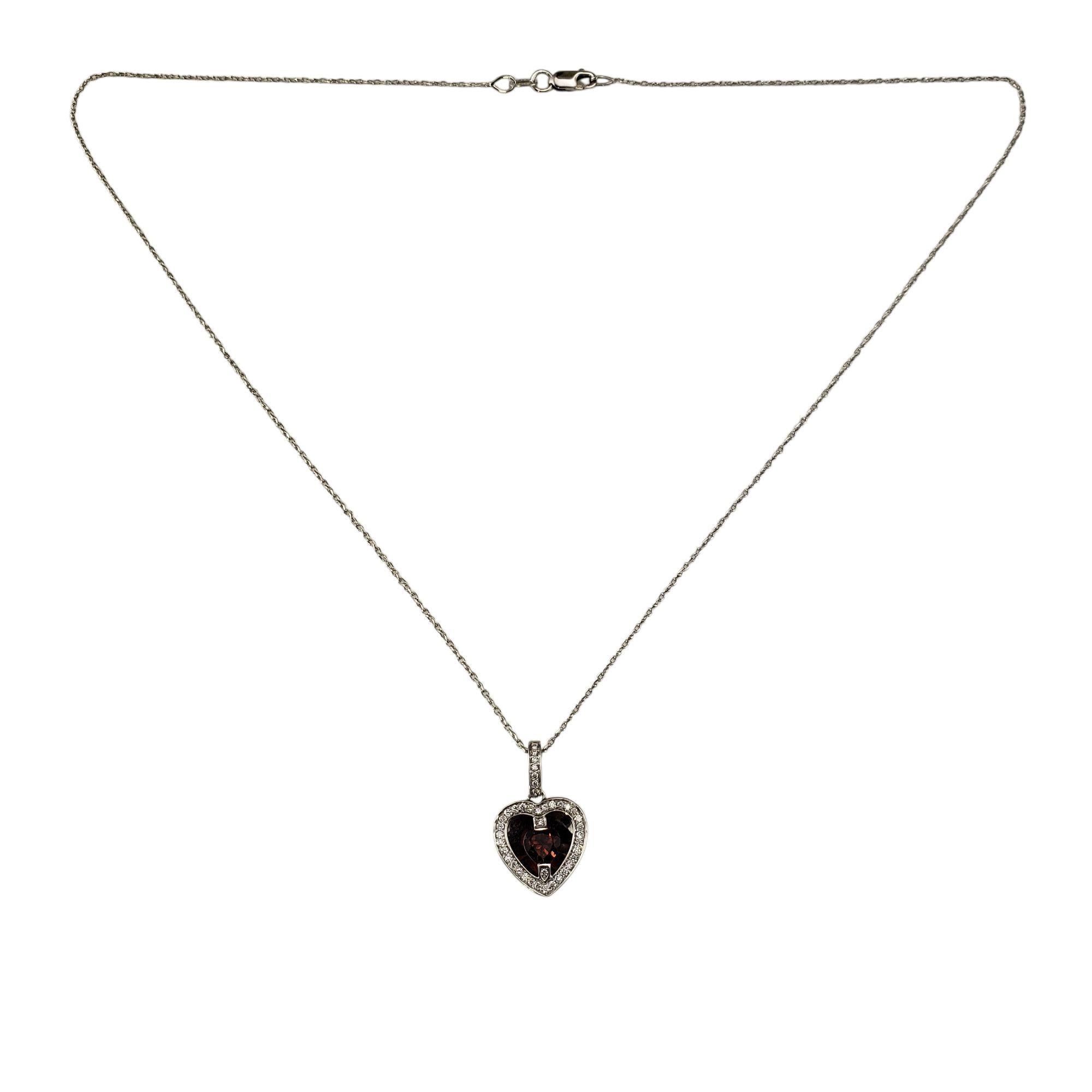 14 Karat White Gold Garnet and Diamond Heart Pendant Necklace JAGi Certified-

This stunning pendant features a heart-shaped garnet (5 mm x 5 mm) set in 14K white gold, surrounded by a halo of 41 round brilliant cut diamonds. The pendant is