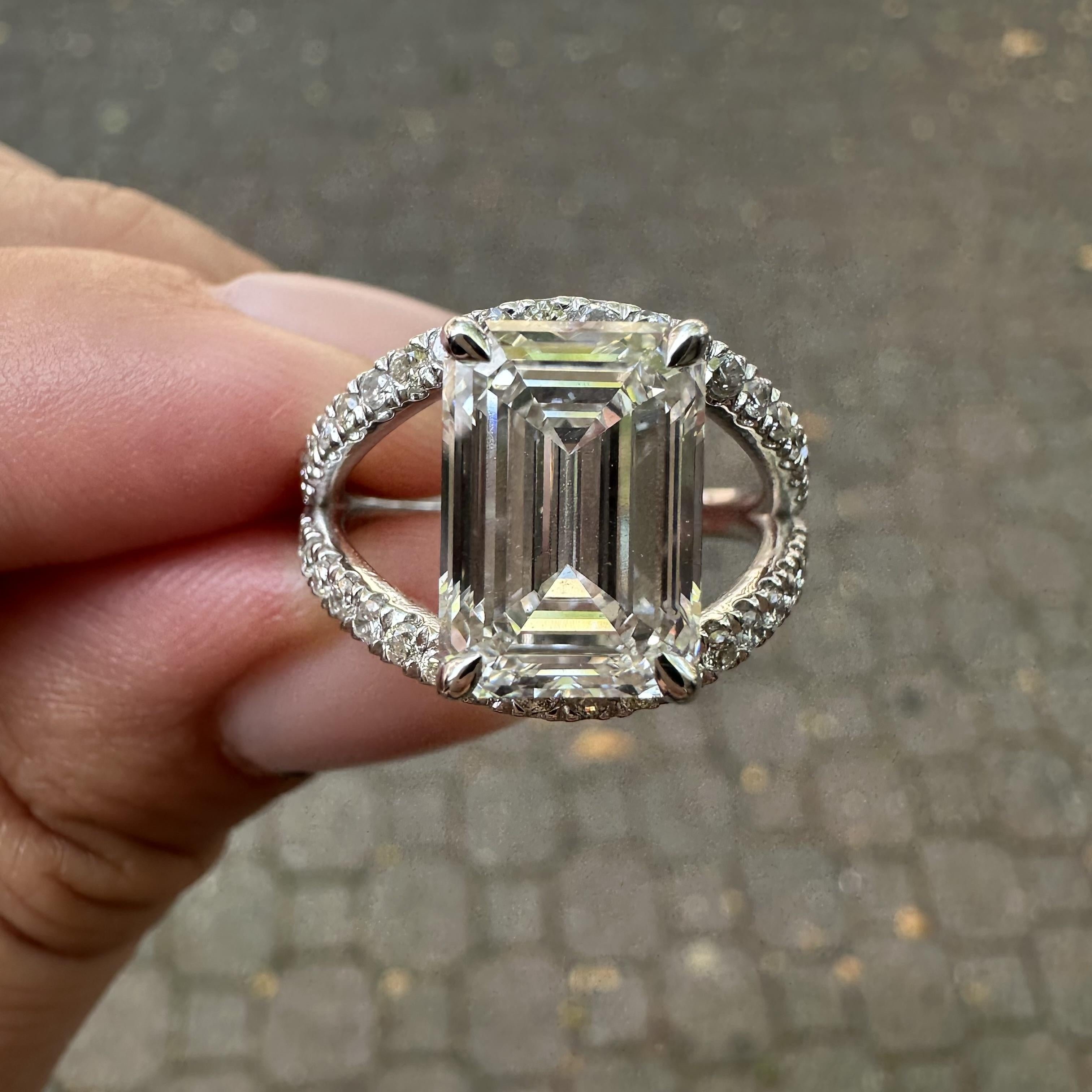--Stone(s):--
(1) Lab Grown Diamond - Long Emerald Cut - Prong Set - G Color - VS2 Clarity - 4.90ct (exact - certified)
** See Certification Details Below for Complete Info **
(40) Natural Genuine Diamonds - Round Brilliant Cut - Prong Set - Nice