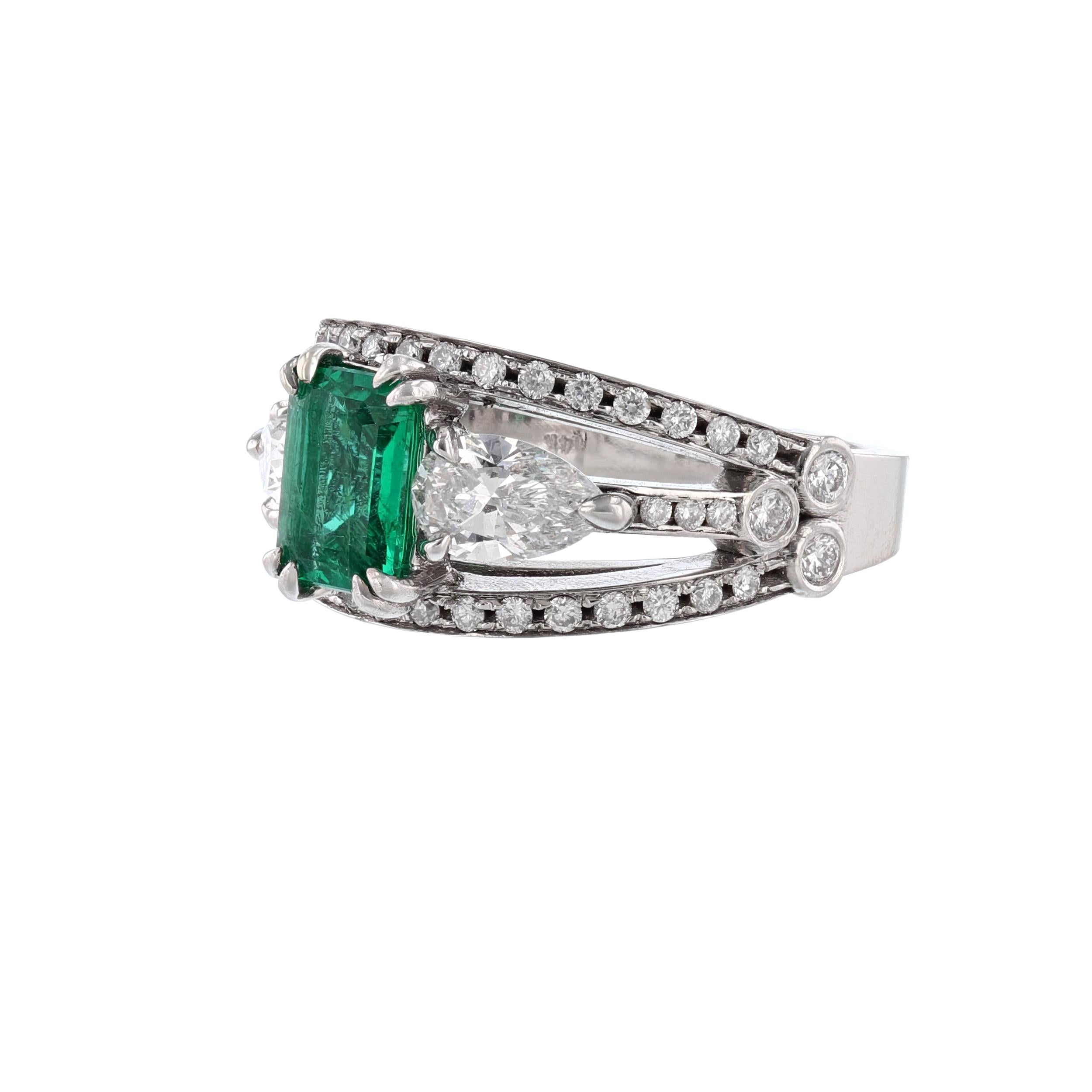 This ring is made in 14k white gold and features 1 octagonal cut, prong set beryl emerald weighing 1.10 carats. With a color grade (Green) and GIA Certificate number 2125281020. Also includes 2 pear shape, prong set diamonds, and 48 round cut, bezel