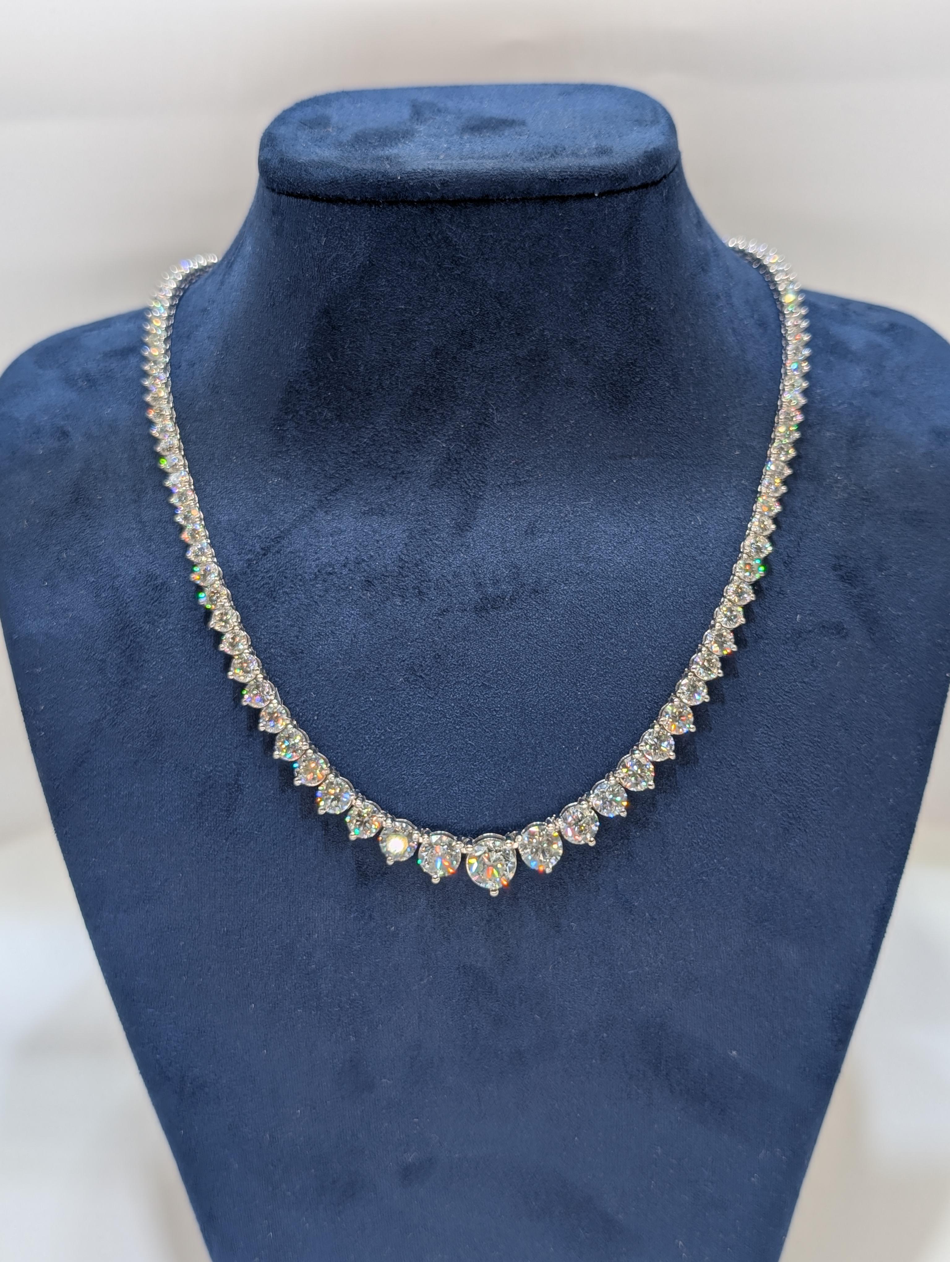 This exquisite 14-karat white gold graduated tennis necklace features a stunning arrangement of diamonds totaling 30.06 carats. Each diamond is meticulously set in a seamless, elegant design, with the stones gradually increasing in size as they move