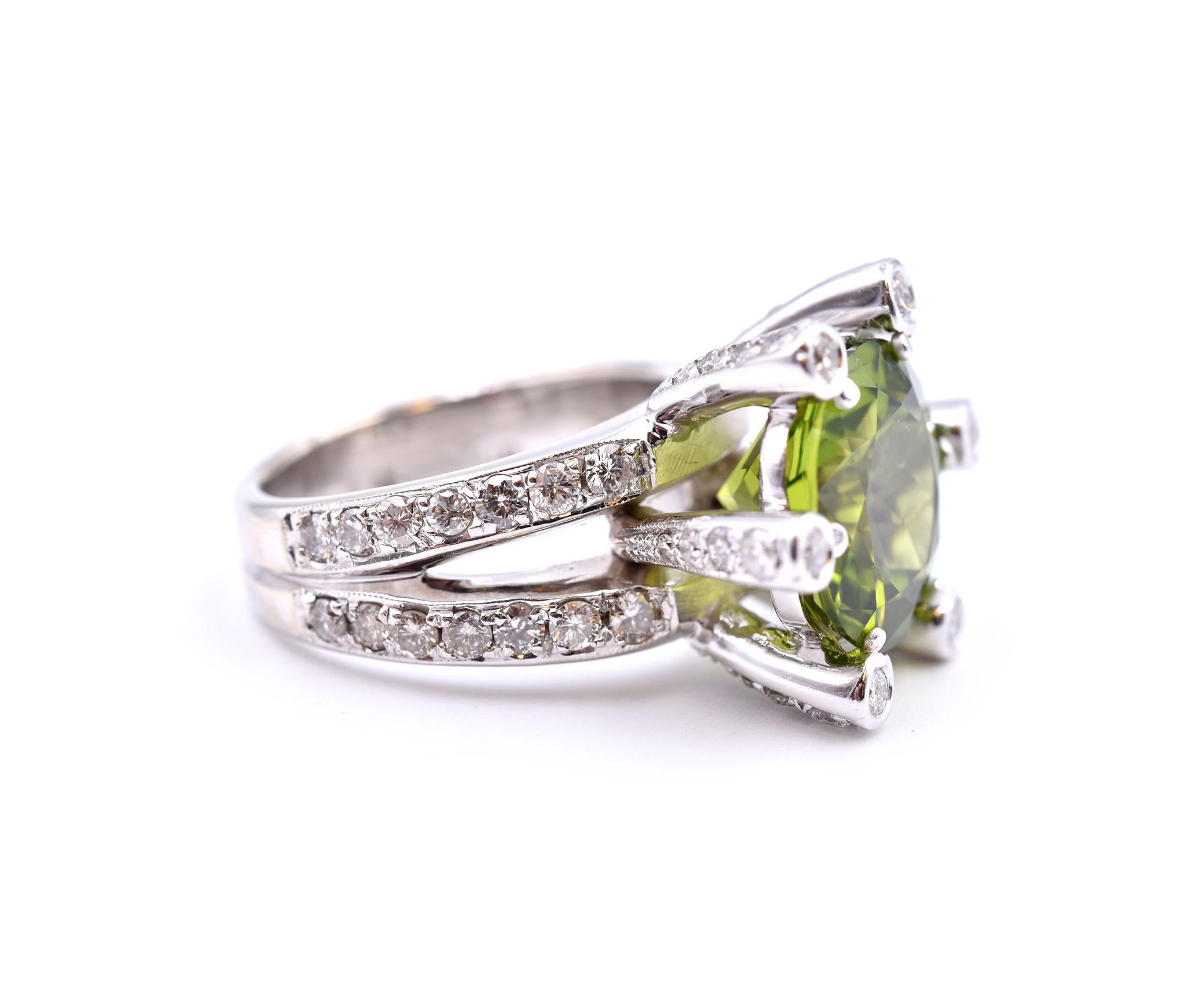 Designer: custom design
Material: 14k white gold
Gemstone: 1 round green tourmaline = 8.26ct
Diamonds: 58 round brilliant cuts = 2.25cttw
Color: H
Clarity: SI1
Dimensions: ring top measures 18.35mm in width
Ring size: 7 (please allow two additional