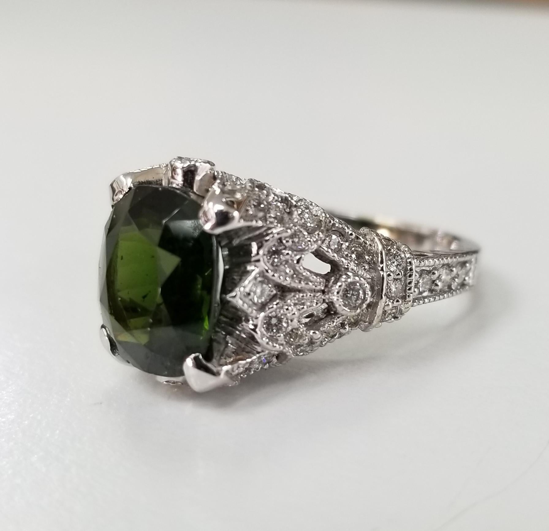 14k white gold Green Tourmaline and diamond ring, containing 1 cushion cut tourmaline weighing 4.78cts. and 96 round full cut diamonds of very fine quality weighing 1.00cts. Set in an 