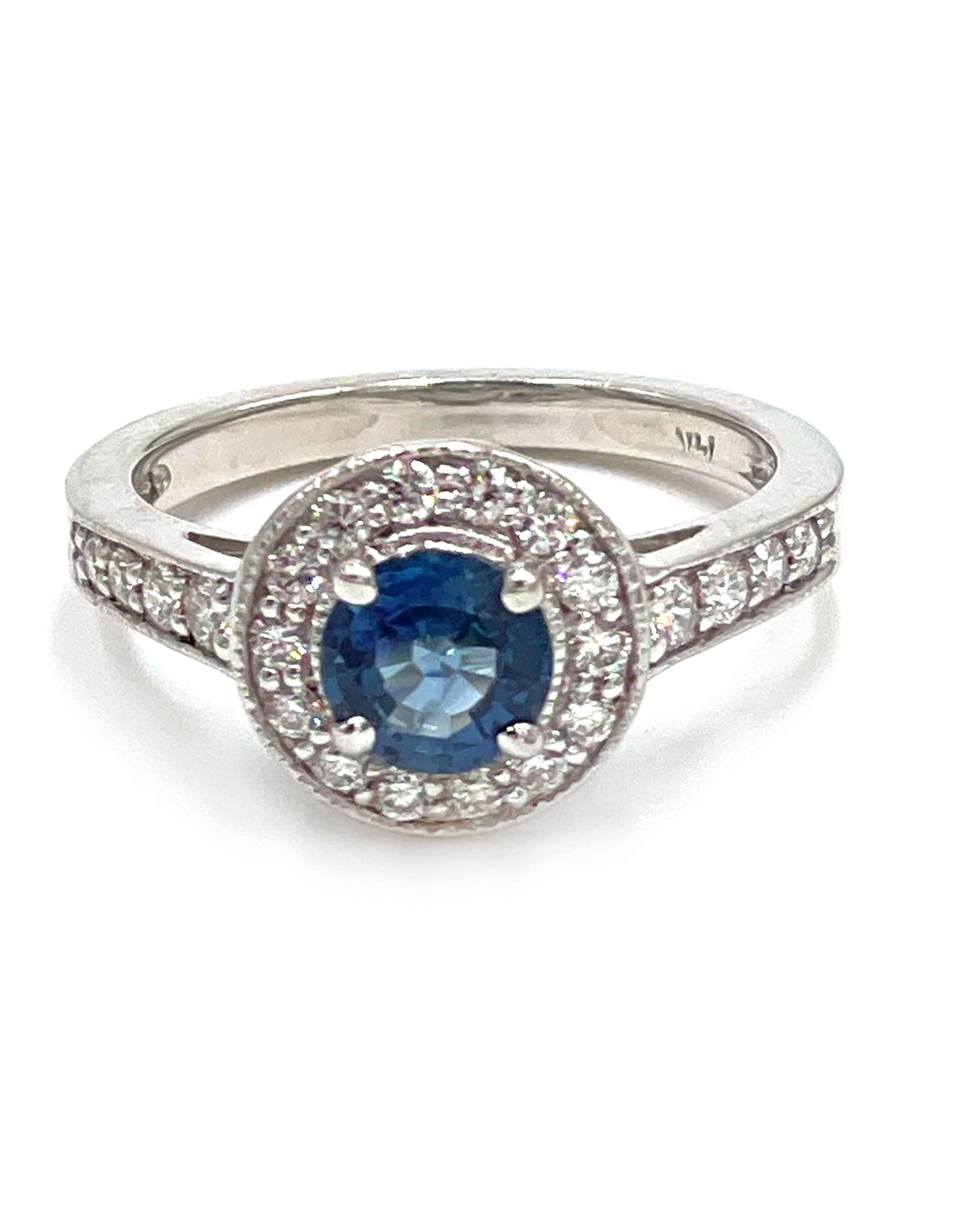 14K white gold halo ring featuring one round faceted blue sapphire 0.90 carats.  The ring is also furnished with 22 round brilliant-cut diamonds 0.45 carats total weight and accented with miligrain detailing.

* Diamonds are G color, SI1 clarity.
*