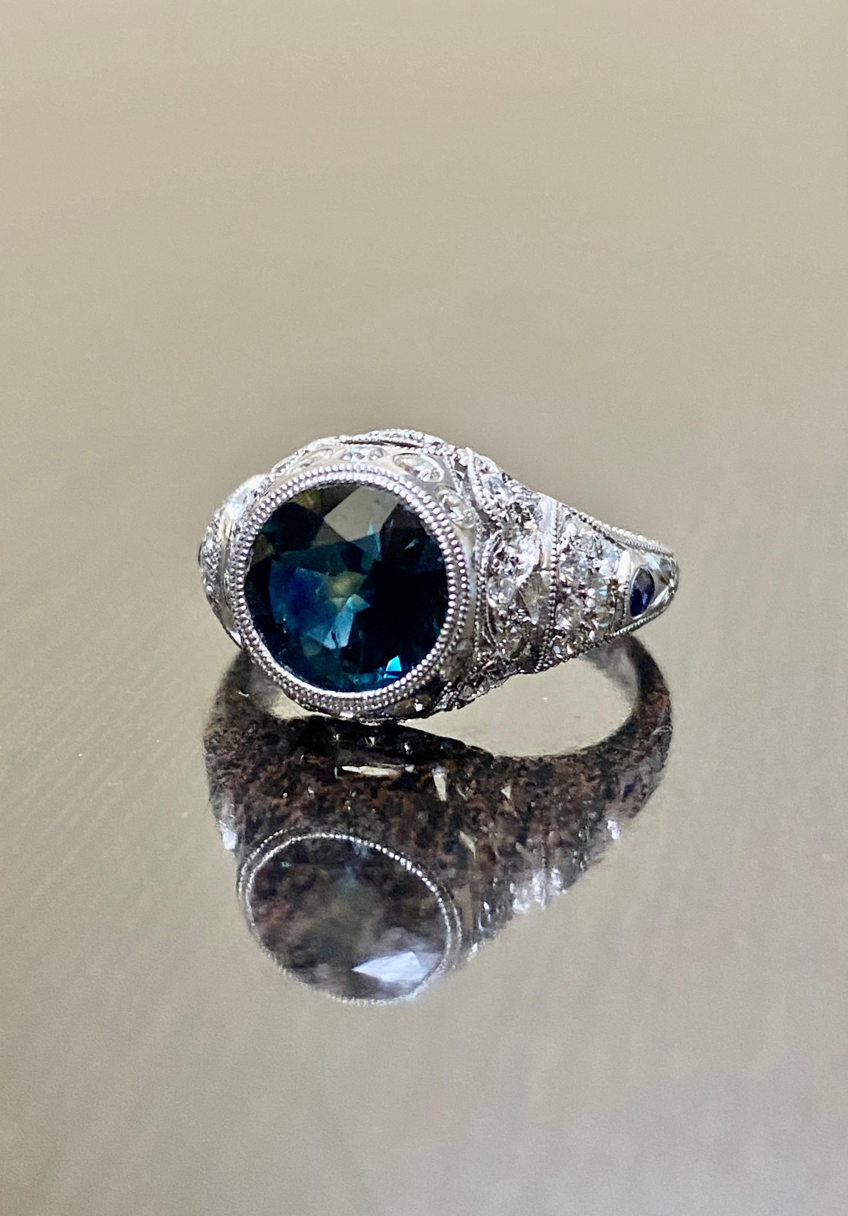 DeKara Designs Collection

Metal- 14K Yellow Gold, .583.

Stones- Center 1 Round Peacock Blue Sapphire 2.25 Carats, 2 Round Sapphire 0.05 Carats, 40 Diamonds G Color VS2 Clarity, 0.72 Carats.

Size- 6.  FREE SIZING!!!!

Beautifully handmade and hand