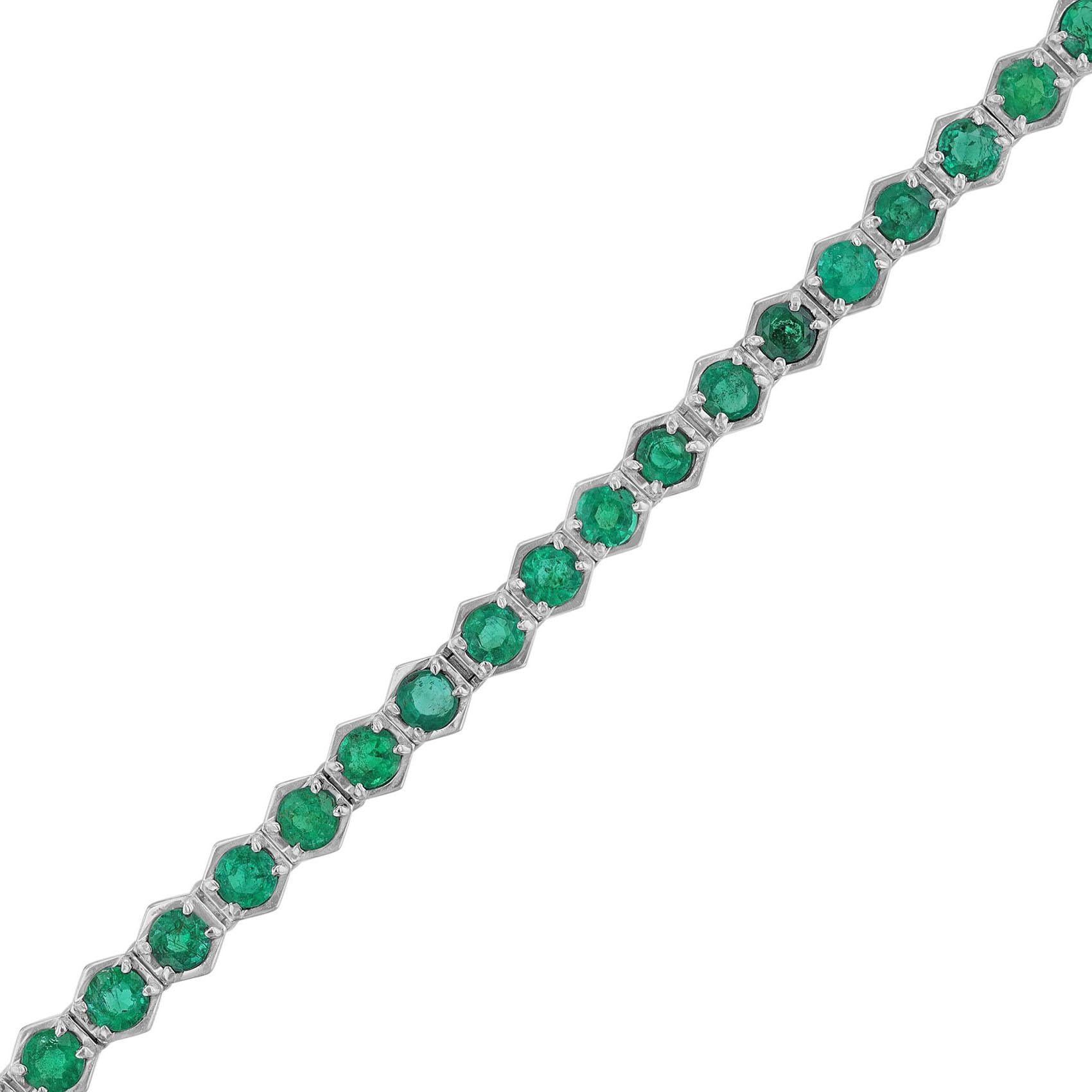 This bracelet is made in 18K white gold. It features 42 round cut emeralds in hexagon bezels. It weighs 3.94 carats. 