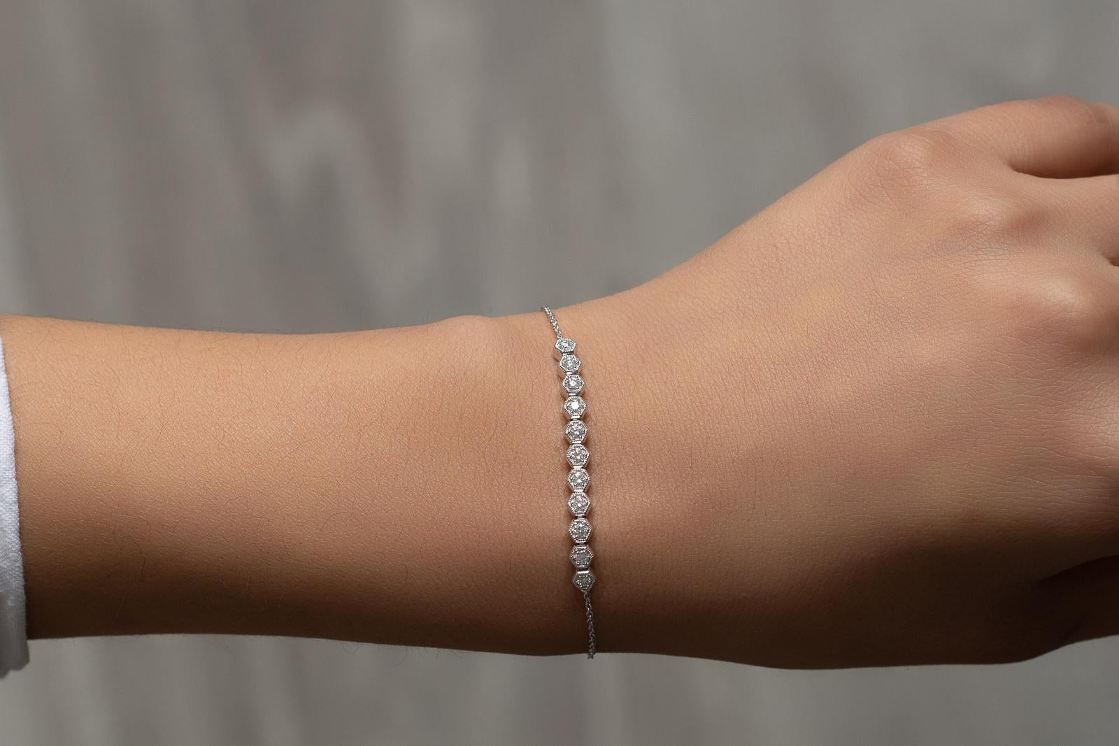 In trend with dainty and minimalistic jewelry, this romantic piece is the perfect stackable bracelet yet it's chic enough to wear as a standout. Layer your style with this 14k white gold bracelet featuring a honeycomb motif made of full cut