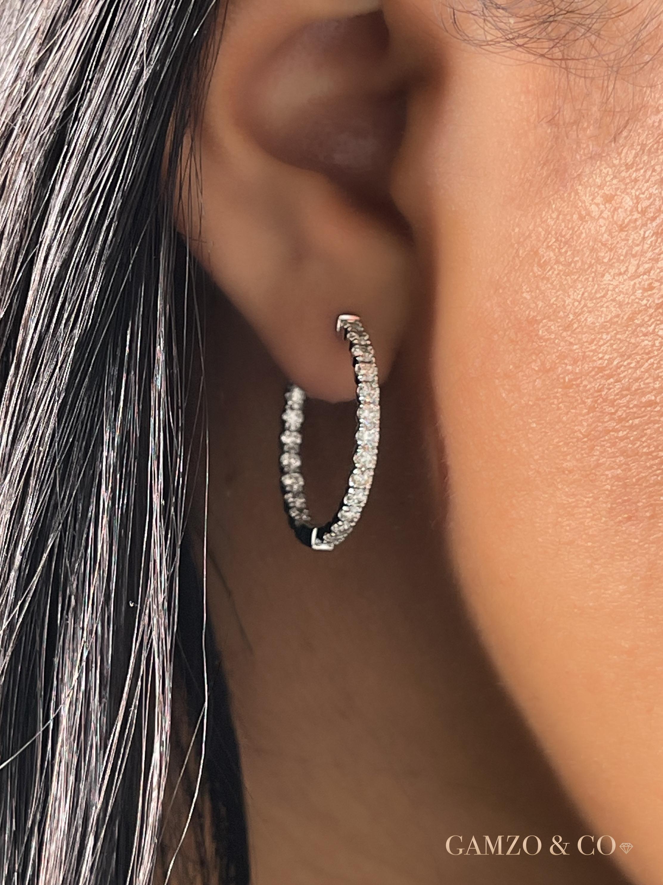 These inside out diamond hoop earrings feature beautiful round diamonds set in a classic 14k gold setting.

Metal: 14k Gold
Diamond Carat Weight (Total for pair): 2ct
Diamond Cut: Round Natural Conflict Free Diamond 
Diamond Clarity: VS
Diamond