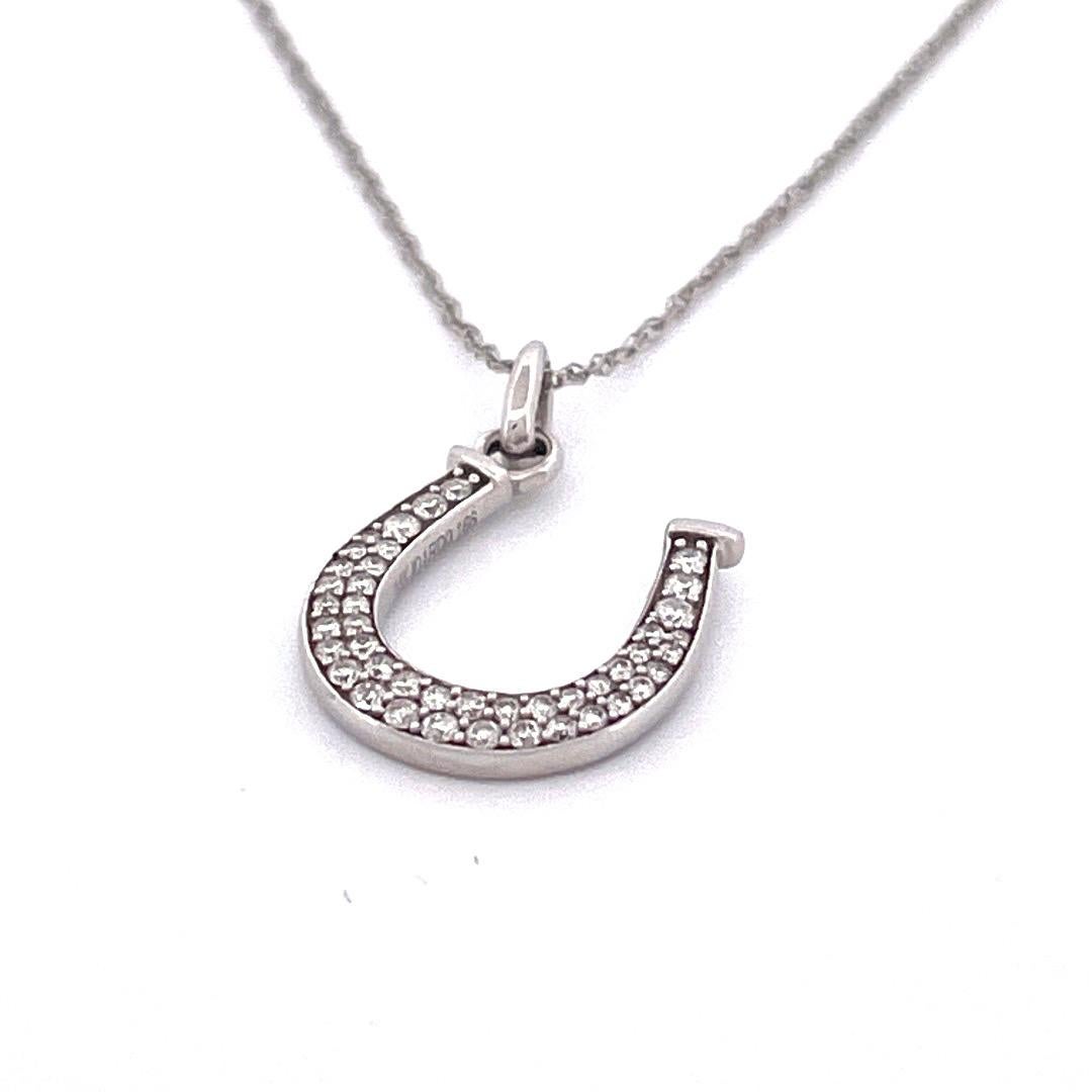 14K White Gold Horse Shoe Pendant Necklace 

Add a touch of timeless allure to your ensemble with our exquisite 14K white gold horse shoe pendant necklace. This stunning piece features a horseshoe-shaped pendant adorned with 0.20 carats total weight