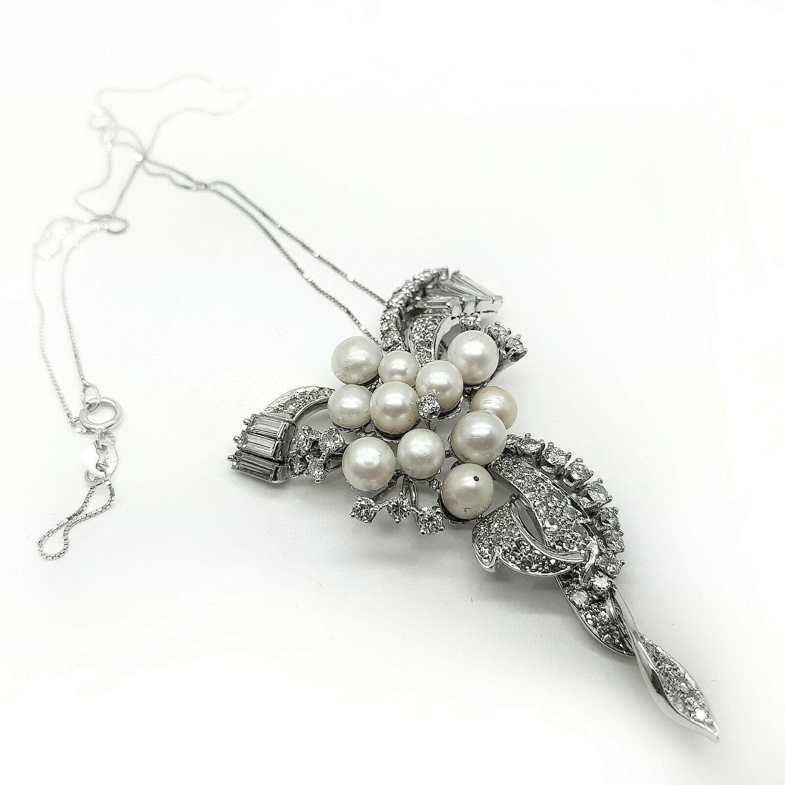 14k white gold seed pearl and diamond pendant brooch with a bright polish finish. Condition is very good. Contains 11 slightly round drilled post set seed pearls; 7 straight baguette diamonds 1.25ct in total weight; 60 single cut natural diamonds