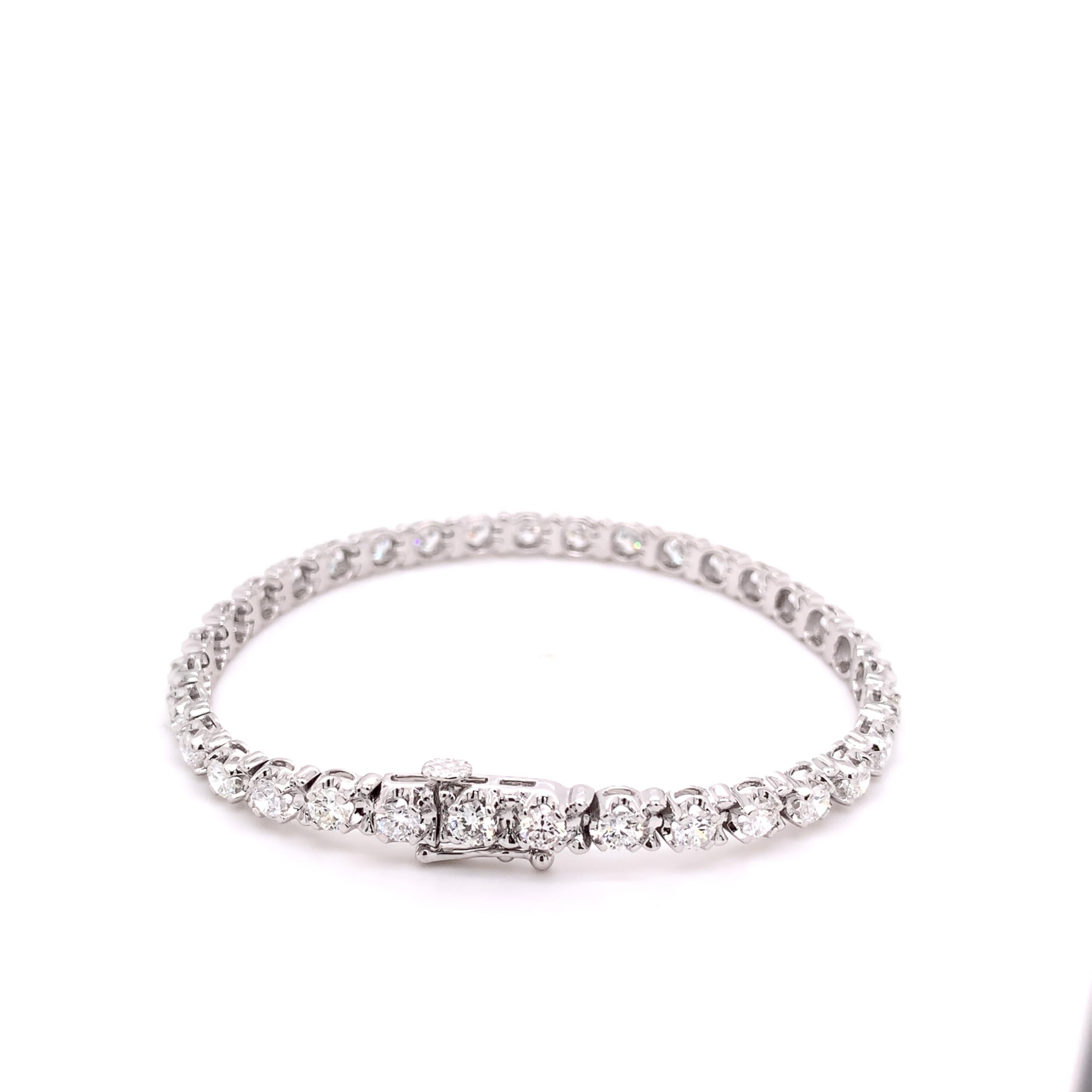 This lab grown bracelet is absolutely stunning and filled with sparkle! It was definitely designed for someone special. It features a total of 34 round prong set lab grown diamonds totaling 5.12 carats (E-F color, VS1 clarity) crafted in luxurious