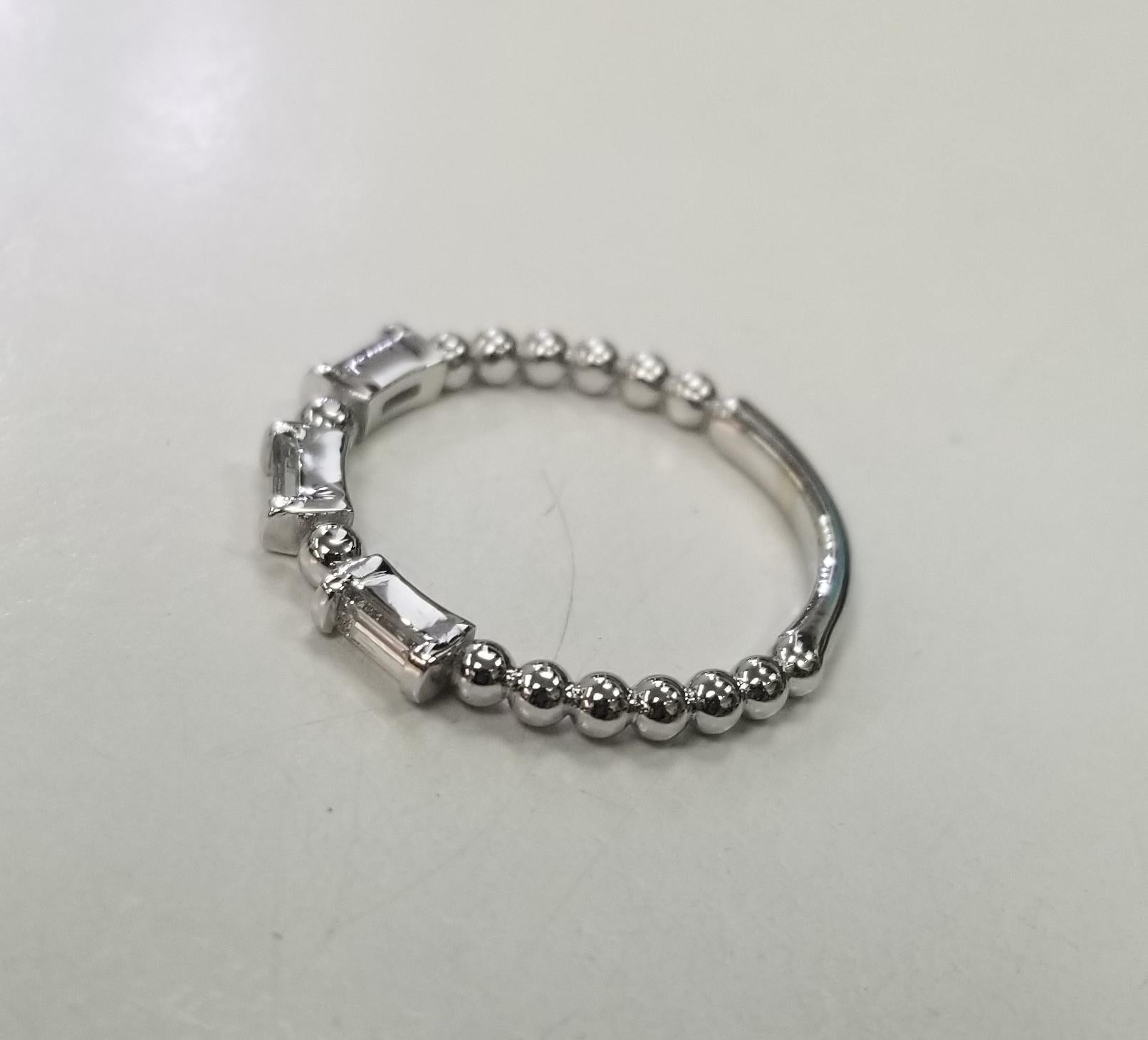Specifications:   
    STONE:3 Baguette cut diamonds weighing .35pts. 
    QUALITY: Color G and clarity VS
    WEIGHT :9 GR
    METAL :14k white gold
    RING SIZE:  6
*Ring can be sized to fit and perfect for Stacking*



