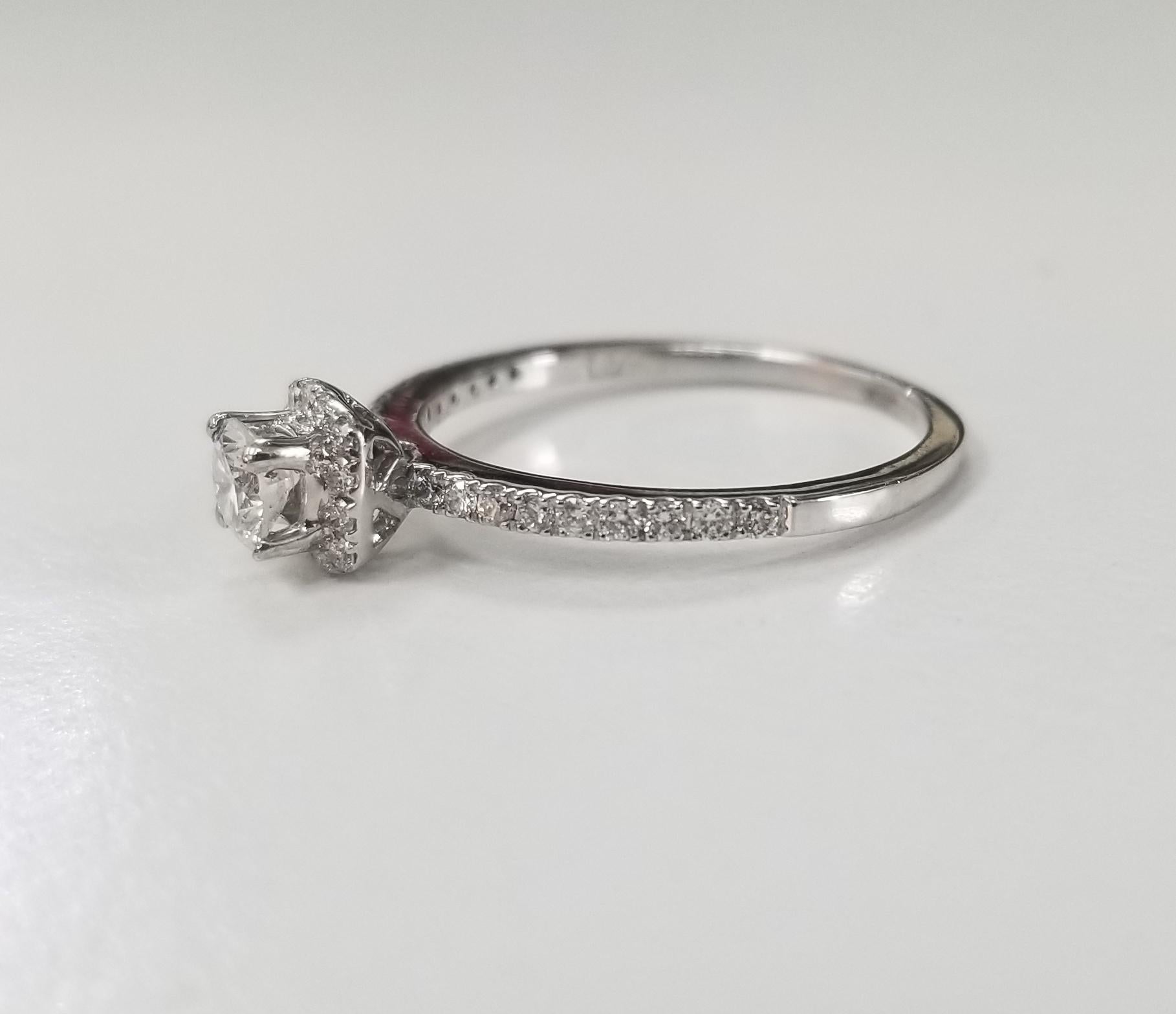 14k white gold ladies diamond halo ring, containing 1 brilliant cut diamond; color 