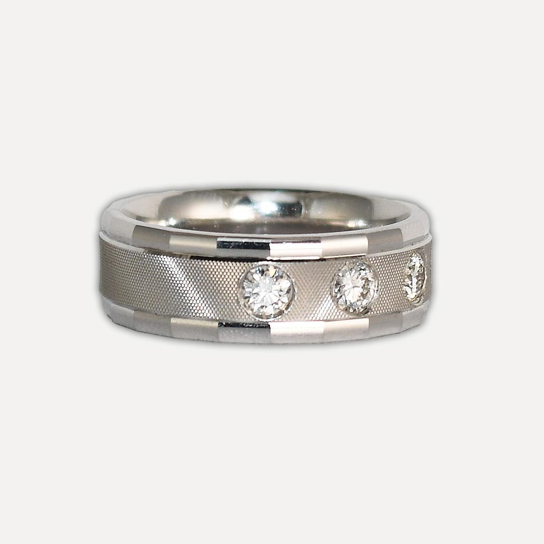 Ladies 14k white gold and diamond band.
Stamped 14k and weighs 9.2 grams.
There are five round brilliant diamonds, 0.50 total carats, H to I color, Si clarity, and good cuts.
The ring has a textured finish in the middle of the ring.
The ring