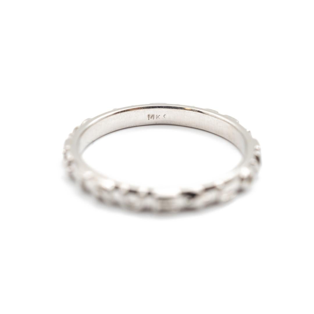 One lady's custom made textured & polished 14K white gold, wedding band with a half-round shank. The band is a size 6 and is 1.30mm thick tapering to 2.43mm in width. The band weighs a total of 2.20 grams. Engraved with 