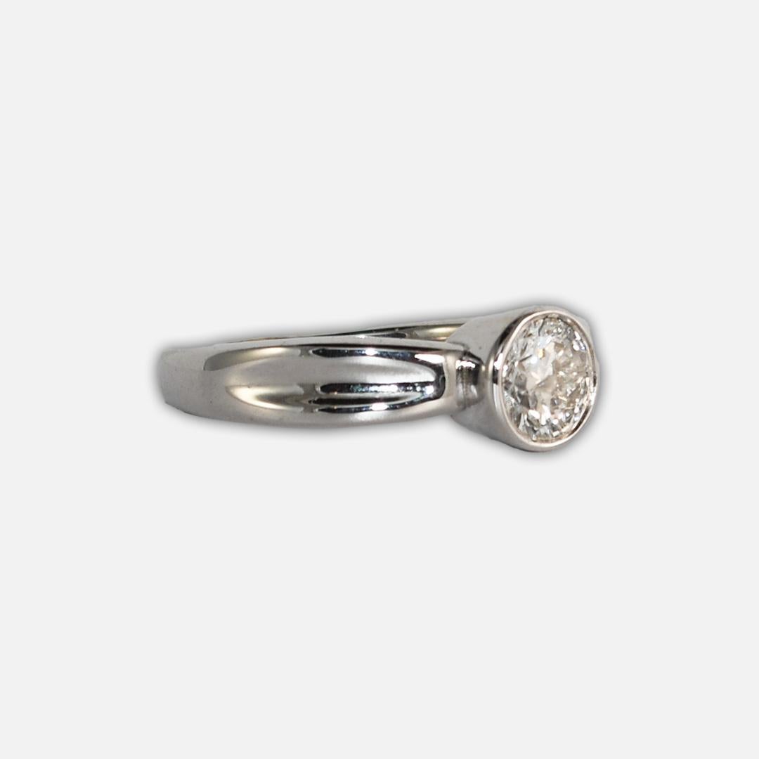 Ladies' diamond solitaire engagement ring with 14k white gold setting.
Stamped 14k and weighs 5.9 grams.
The diamond is a round brilliant cut, approximately .88 carats, j - k color, i1 clarity.
The top of the ring measures 7.5mm wide.
Ring size is 8