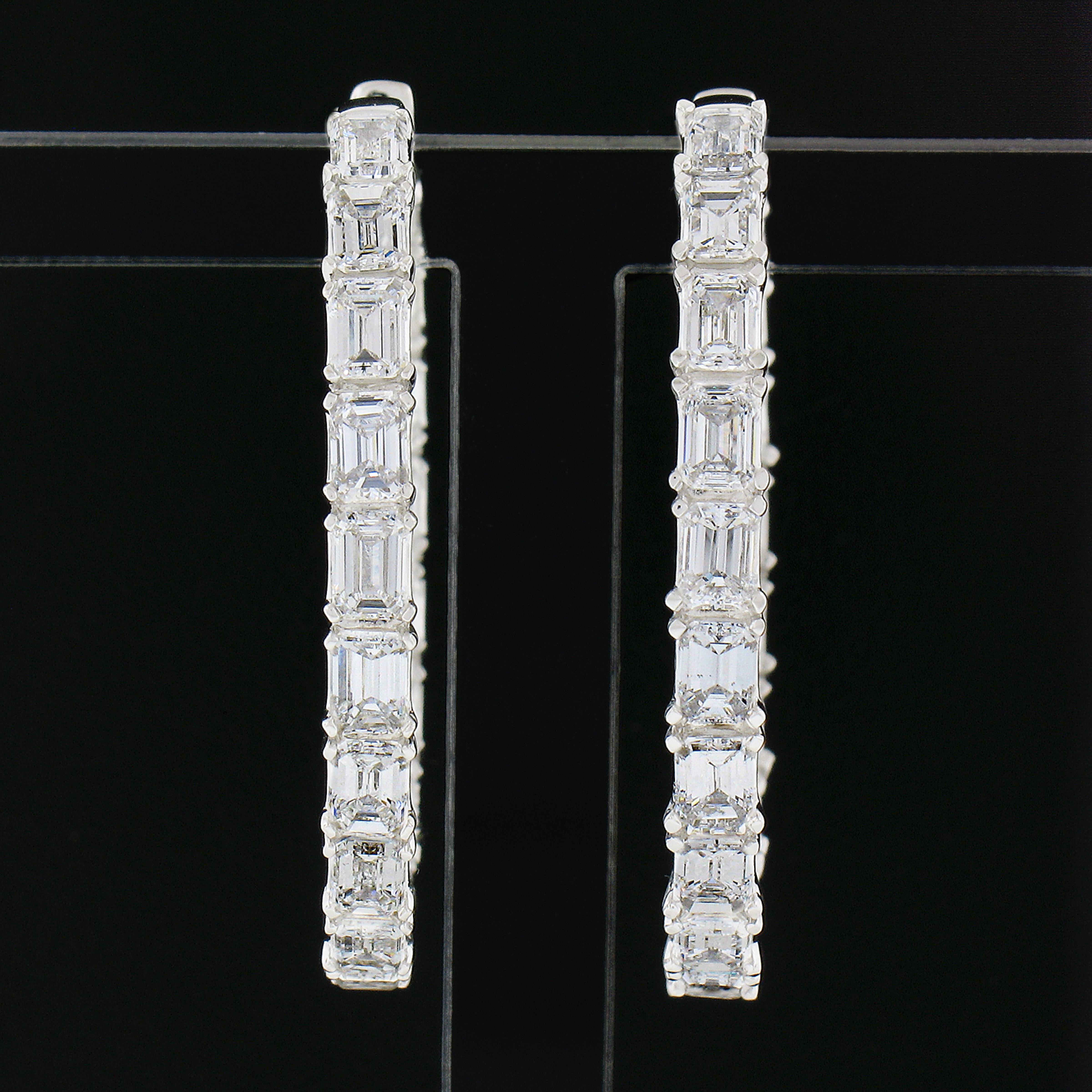 These stunning, super elegant and rich looking hoop earrings are crafted in solid 14k white gold and set with approximately 5 carats of the finest quality emerald cut diamonds throughout the oval in and out design. These top quality diamonds are