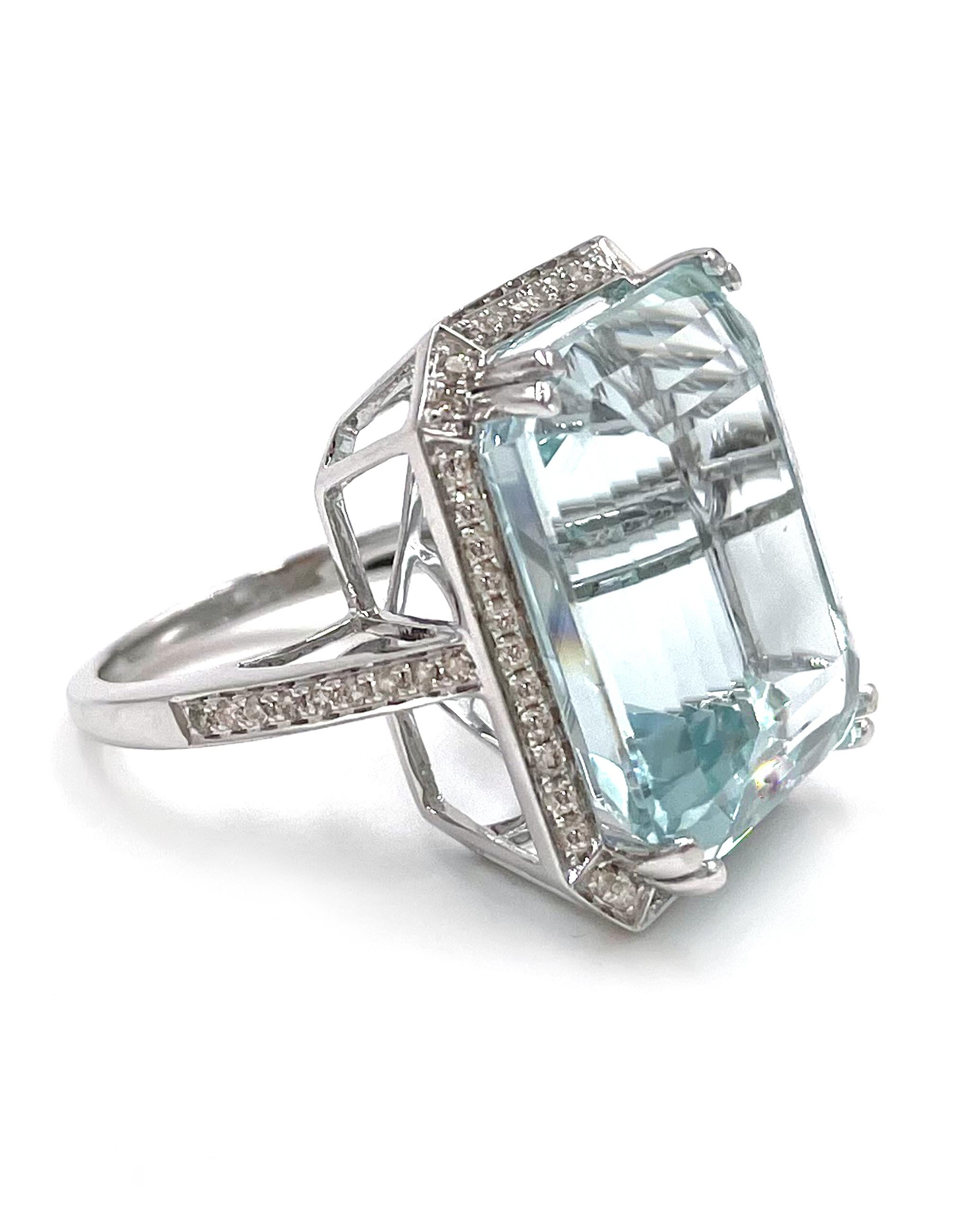 An everyday statement! This 14K white gold ring features a spectacular step cut aquamarine weighing 23.93 carats.  The ring is furnished with an additional 62 round diamonds weighing a total of 0.52 carat (H/I color, SI clarity).

