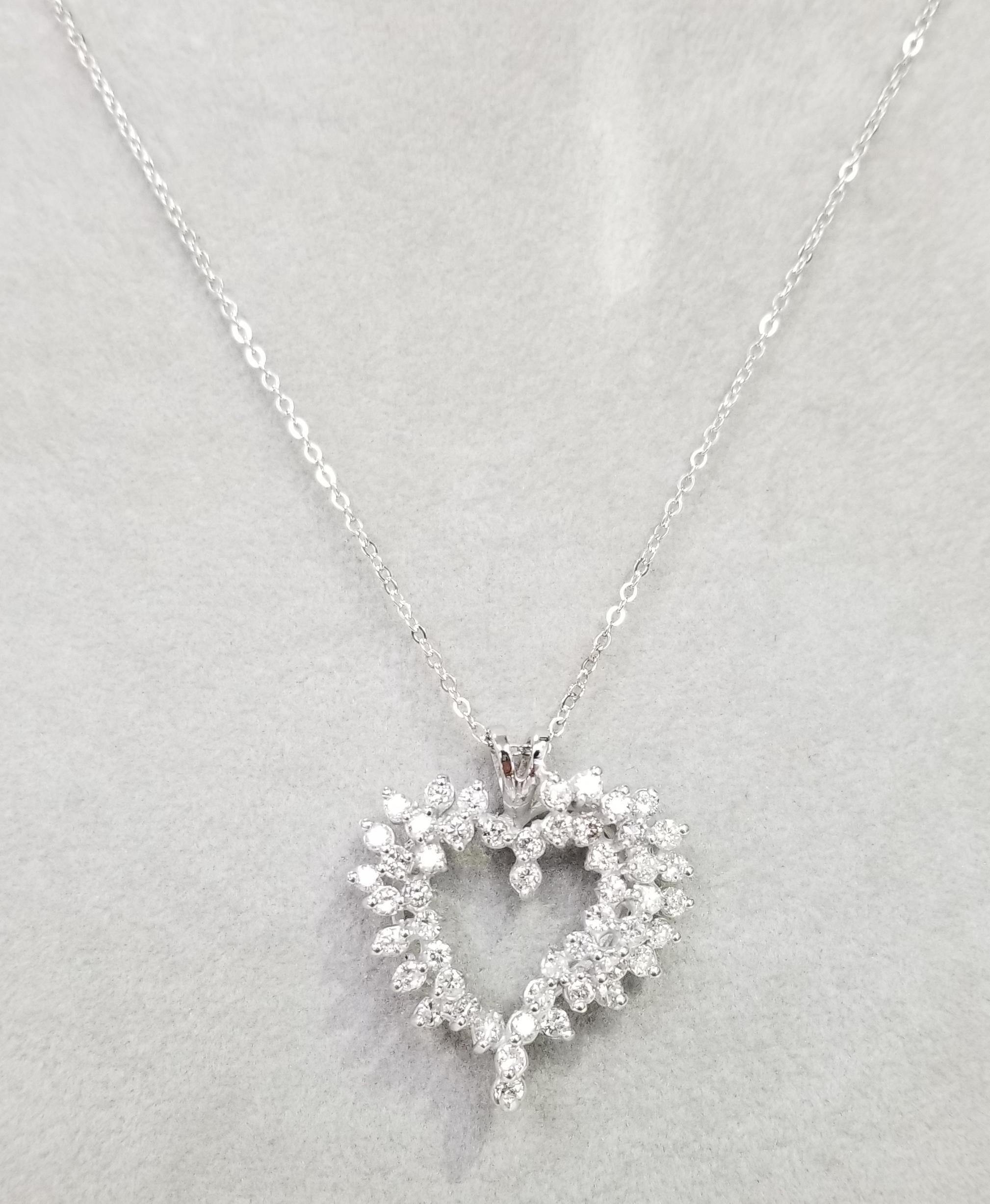 14k white gold large diamond heart pendant containing  50 round full cut diamonds weighing 2.25cts. color G, clarity SI on a 16 inch chain.