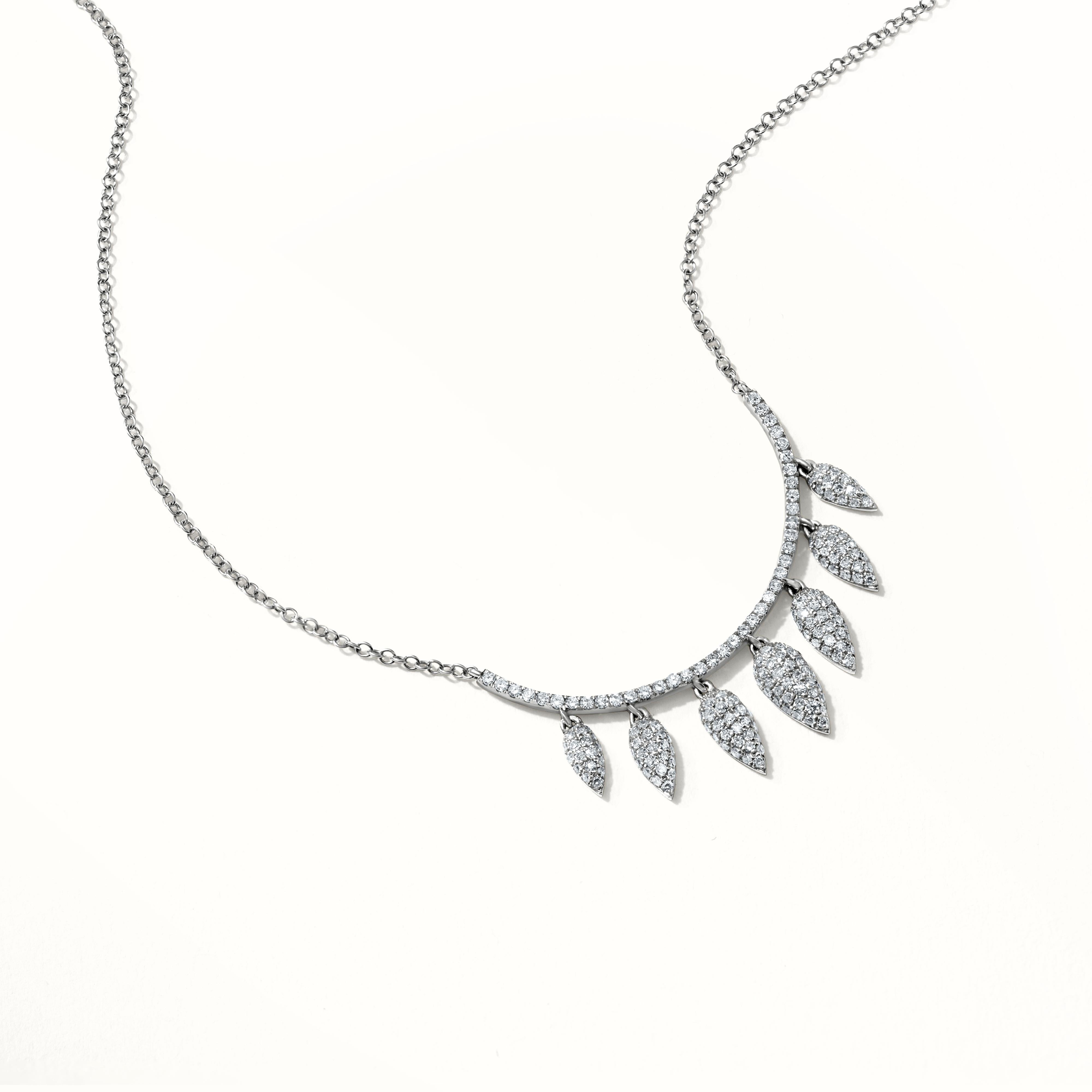 This magnificent Luxle leaf pendant necklace is made in 14K White Gold and sways with grace. The leaf patterns are encrusted with 0.56 carats of round single-cut diamonds that flash with brilliance. This pendant necklace is understated but