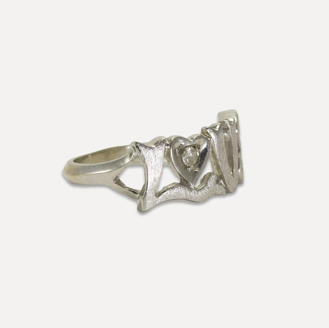 14K White Gold LOVE ring with single-cut Diamond.
Tests 57% pure on x-ray gun.
Weighs 2.2gr, size 4 3/4.