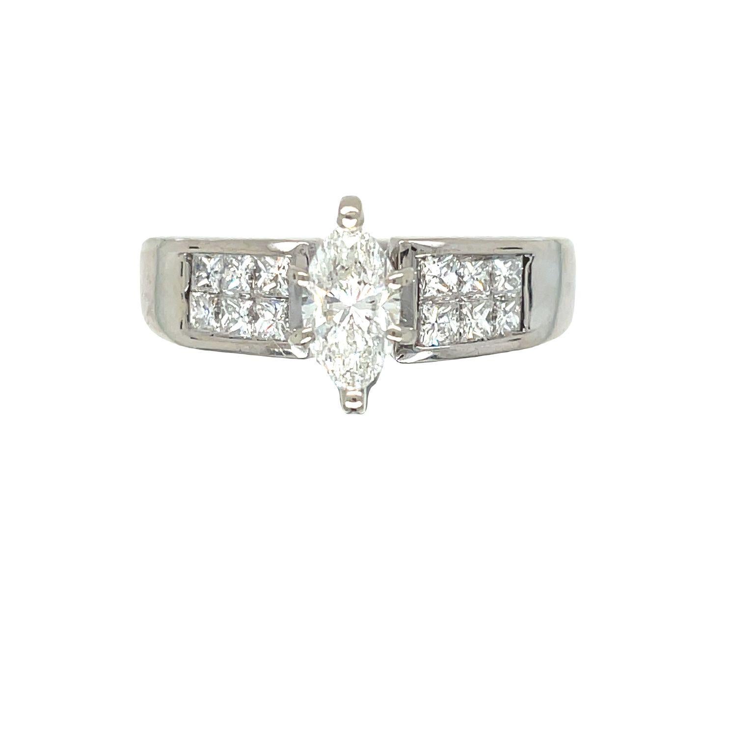 A stunning vintage engagement ring featuring a sparkling marquise cut diamond at the center weighing 0.75 carats, held in a six-prong setting that rises above the rest of the ring. The shank is adorned with two rows of princess cut diamonds,