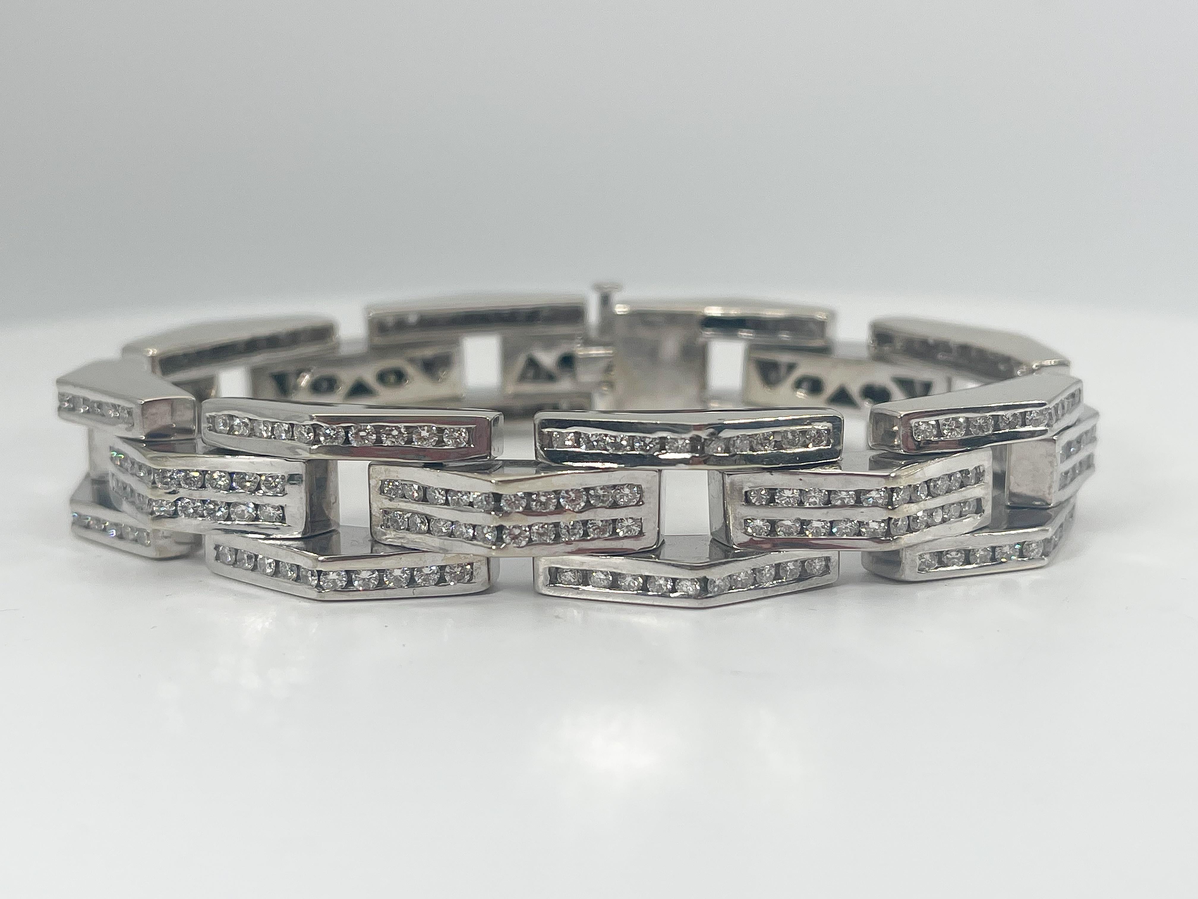 14k white gold men's 5 CTW diamond fancy link bracelet. The diamonds in this bracelet are all round, the length is 8 1/2 inches, the width is 14 mm, has a hidden clasp to open and close, and it has a total weight of 108.5 grams.