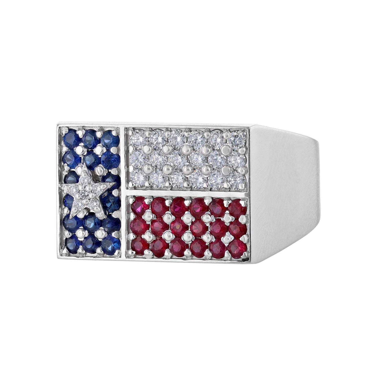 This men's Texas flag ring is made in 14K white gold. It features 16 blue sapphires weighing 0.52 carat.. It also includes 18 rubies weighing 0.59 carat, and 24 diamonds weighing 0.53 carat. All stones are pave’ set. The ring has a color grade (H)