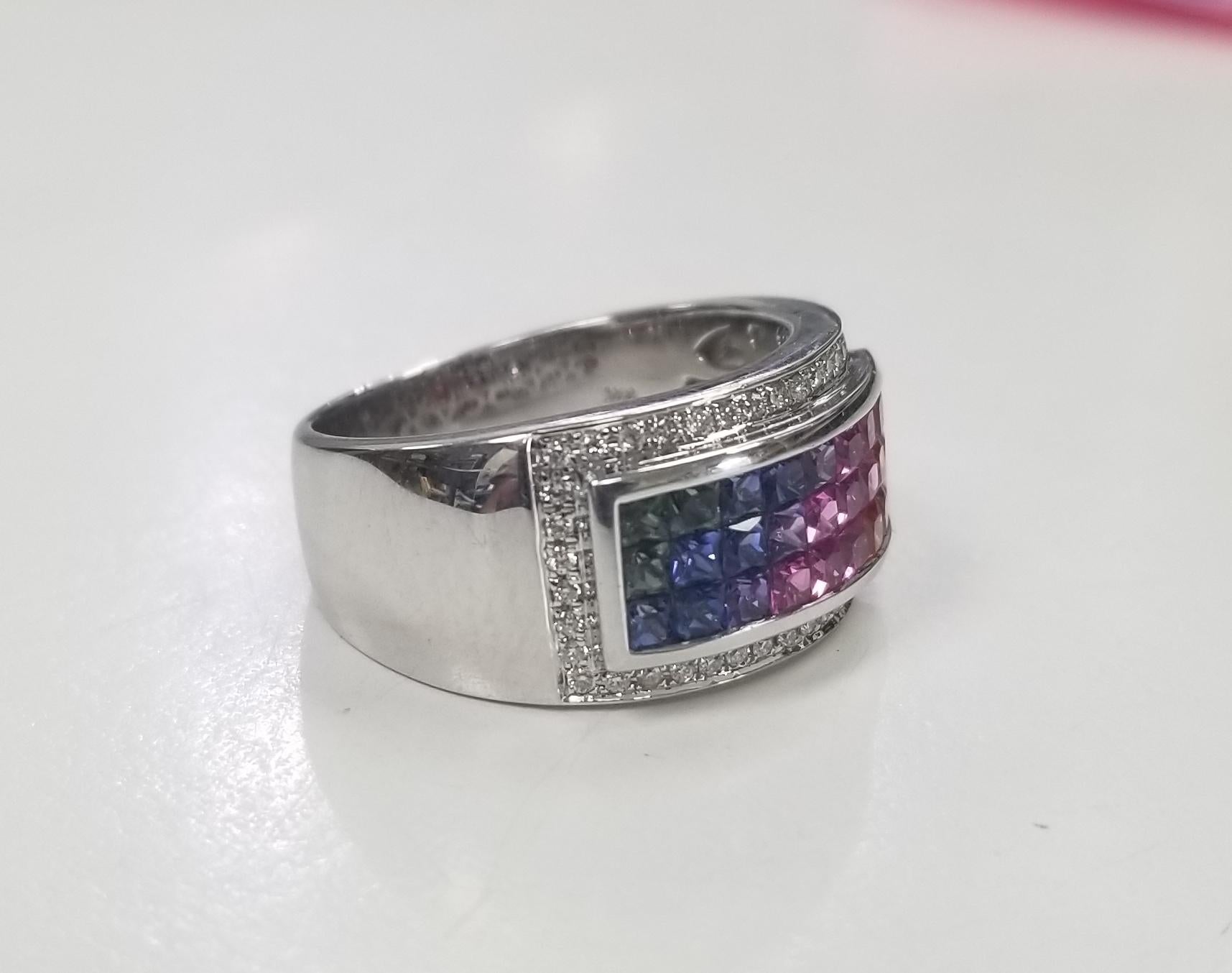 14k white gold multi colored princess cut sapphires surrounded by diamonds, containing 36 princess cut invisible set multi colored sapphires weighing .75pts. and surrounded by 50 round full cut diamonds of very fine quality weighing .25pts. ring