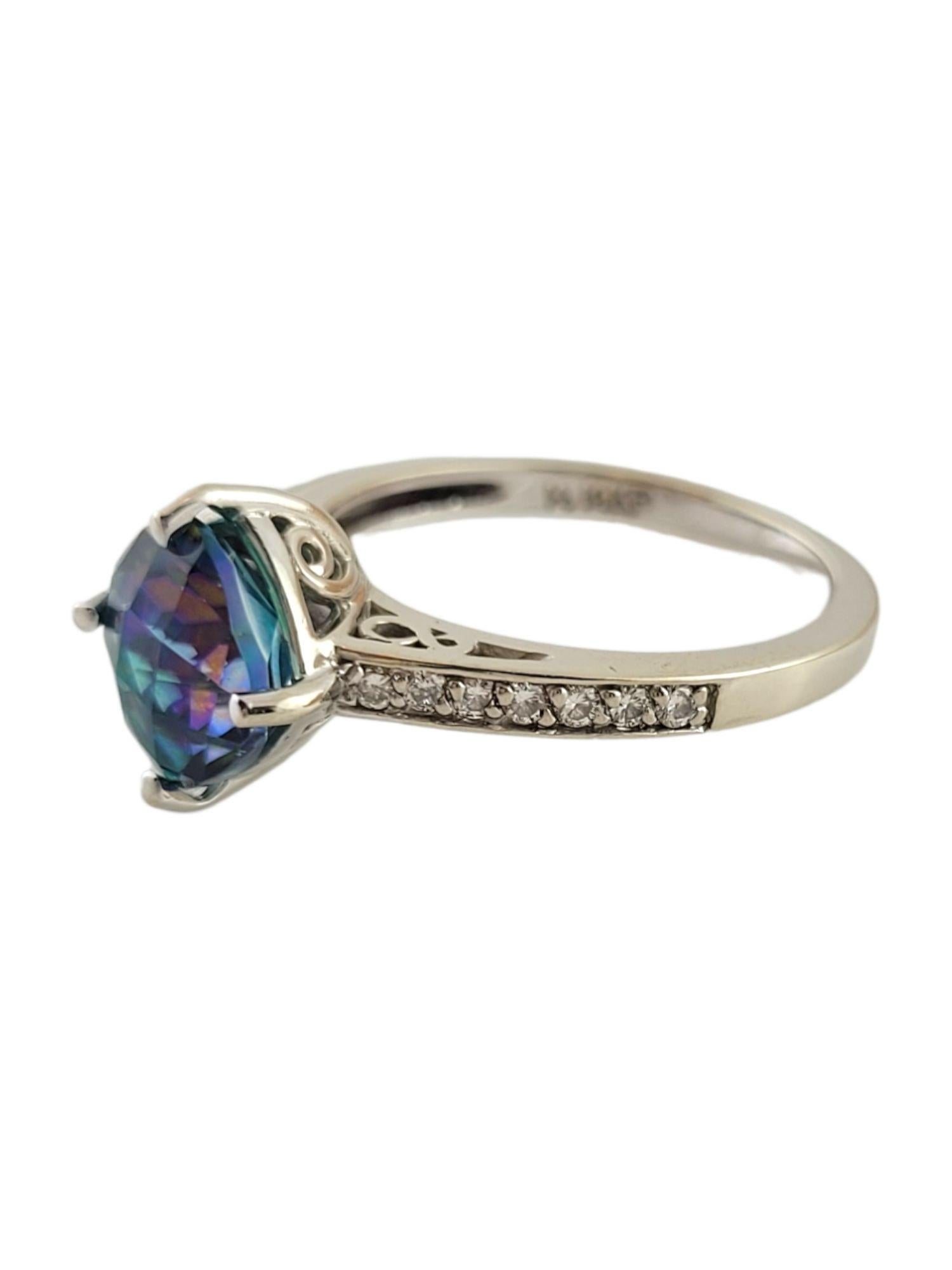 Gorgeous square mystic topaz stone and 14 sparkling, round cut diamonds set in a 14K white gold ring!

Approximate total diamond weight: .15 cttw

Diamond clarity: SI2-I1

Diamond color: I-J

2.88ct Mystic Topaz - color created by coating.

Square