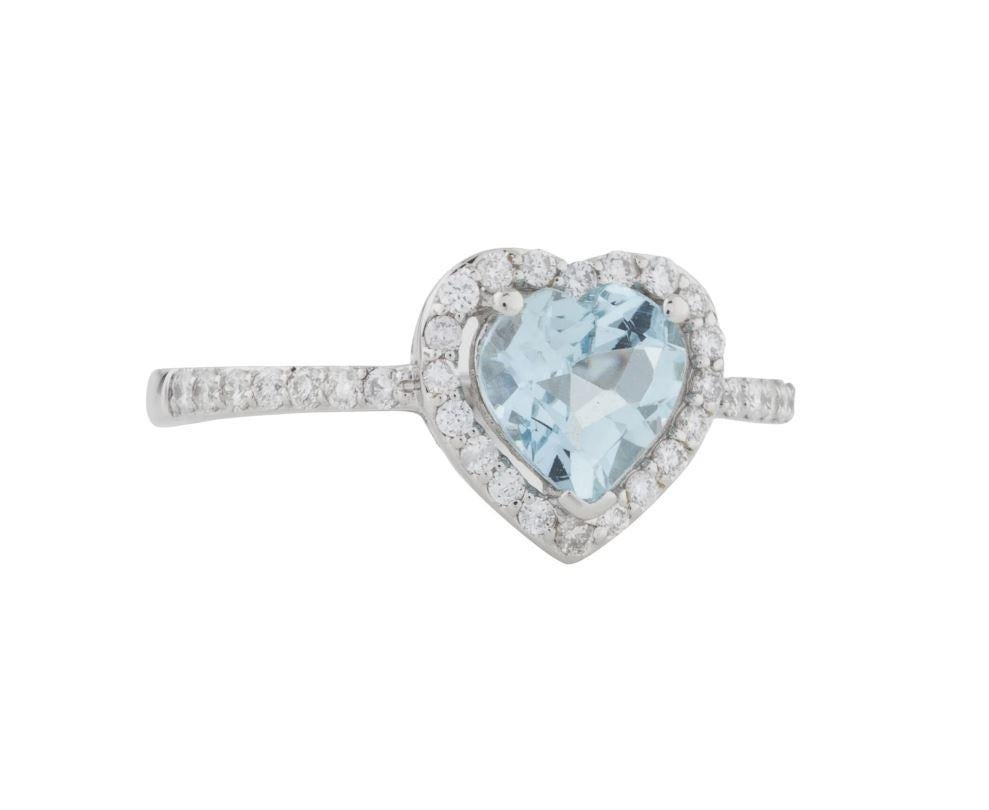 This is a marvelous natural aquamarine and diamond heart-shaped ring set in solid 14K white gold. The aquamarine color is excellent and is set on top of a gorgeous diamond-encrusted boundary. The ring is stamped 14K and is a true