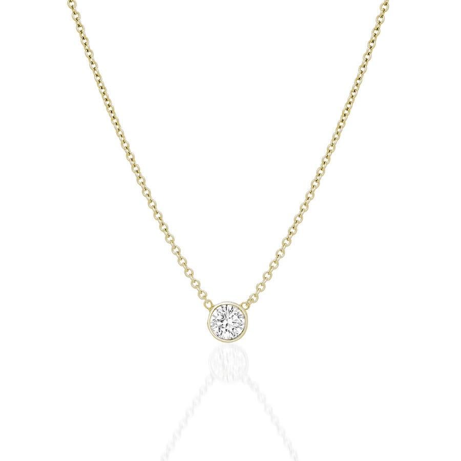 This diamond necklace features an elegant round diamond in 14k gold.

Gold: 14k
Setting: Bezel
Clasp: Lobster Claw Clasp
Color: White Gold
Diamond Cut: Round
Diamond Color: F-G
Diamond Clarity: VS-SI 
Necklace Length: 16 Inch 
Carat Weight: 0.50