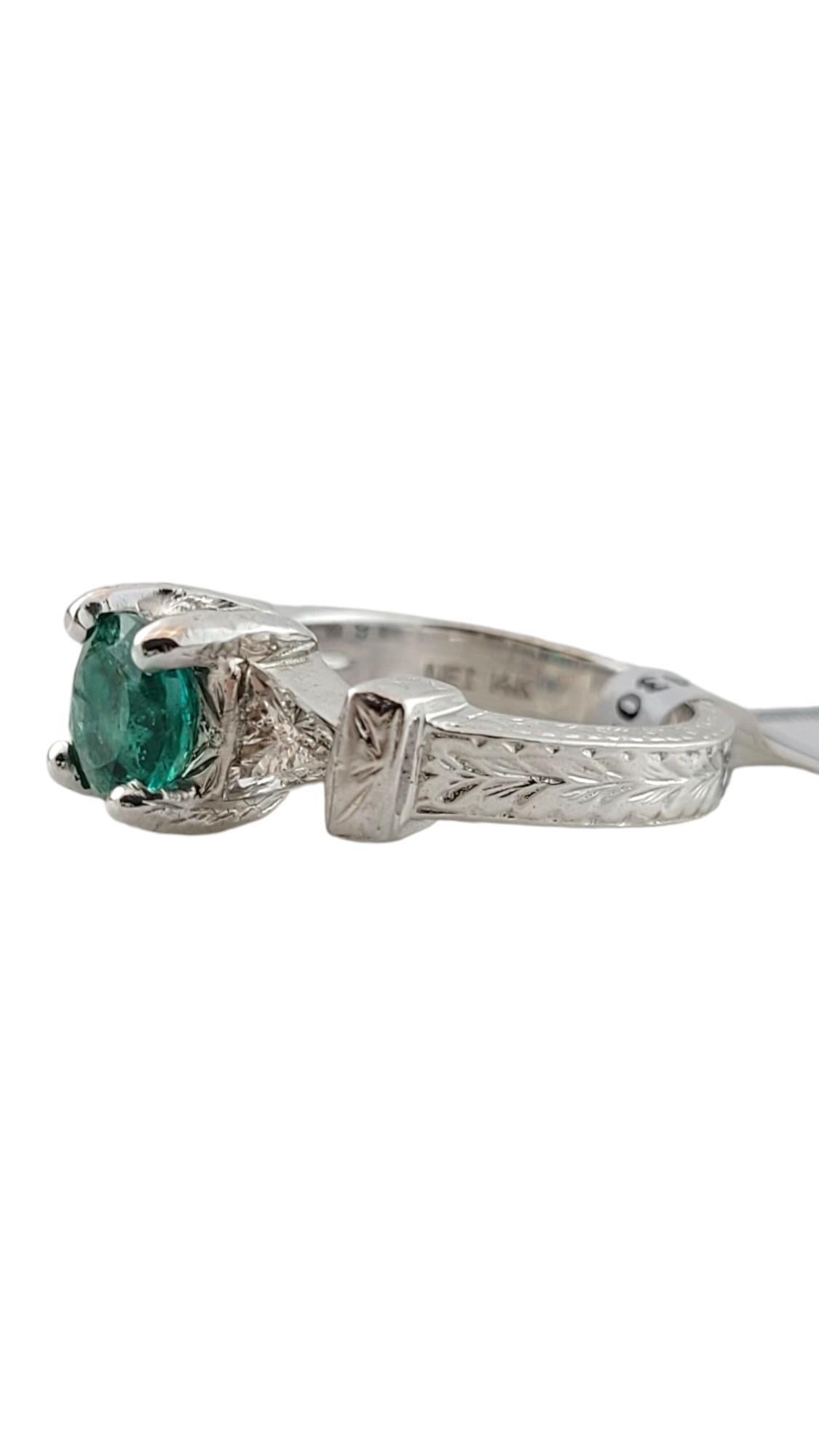 IGI Certified 14K White Gold Natural Emerald and Diamond Ring Size 5.5

This beautiful natural emerald and diamond ring is set in a 14K white gold mounting

The center round mixed cut emerald is 1.21 cts.

Two triangular modified brilliant diamonds