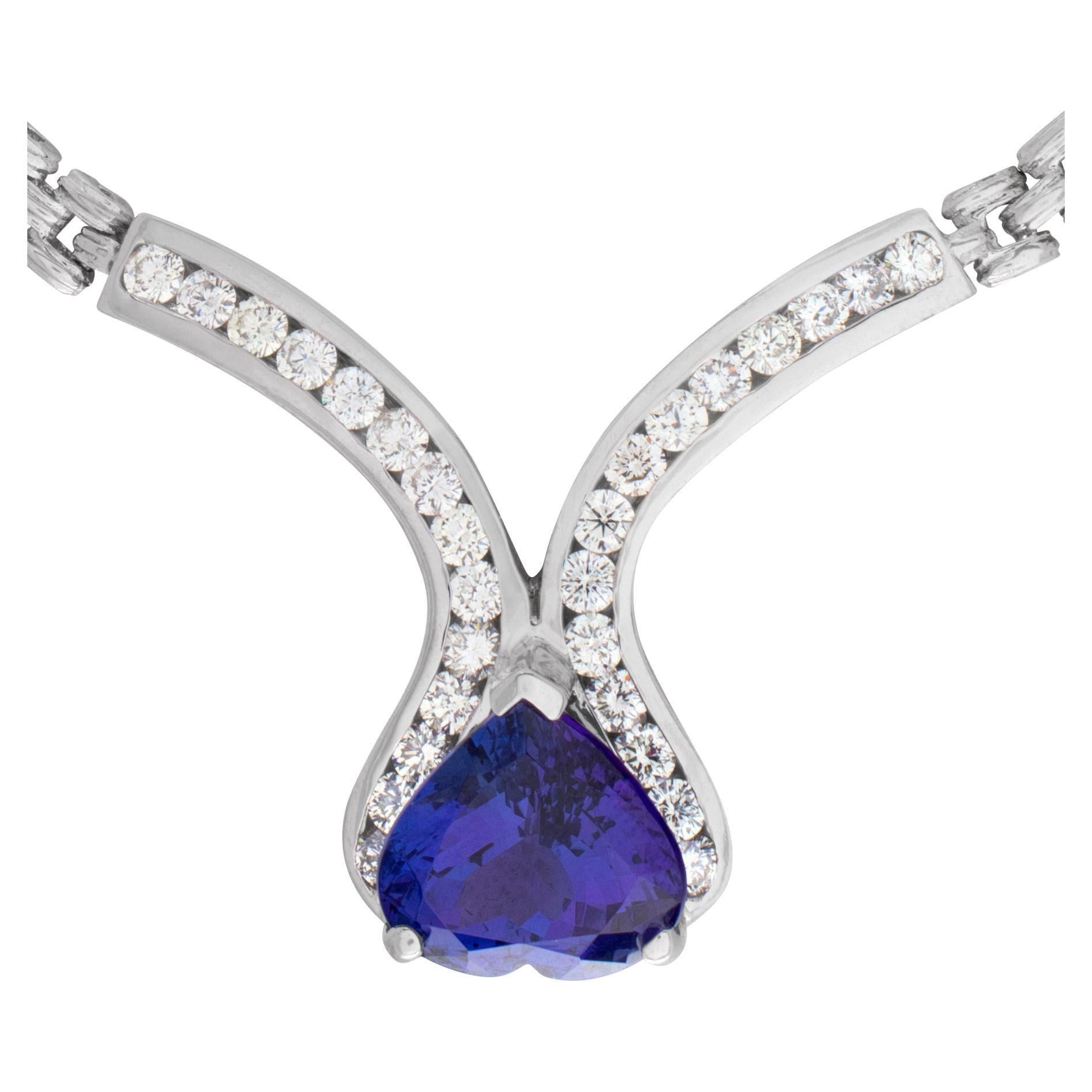 Glamorous necklace with a 13.15 carat heart shape tanzanite surrounded by approx. 3.30 carat full cut, round brilliant diamonds set in 14k white gold. Diamonds estimate; G/H color. VS clarity. Heavy solid link chain/necklace is 16 inches cb .