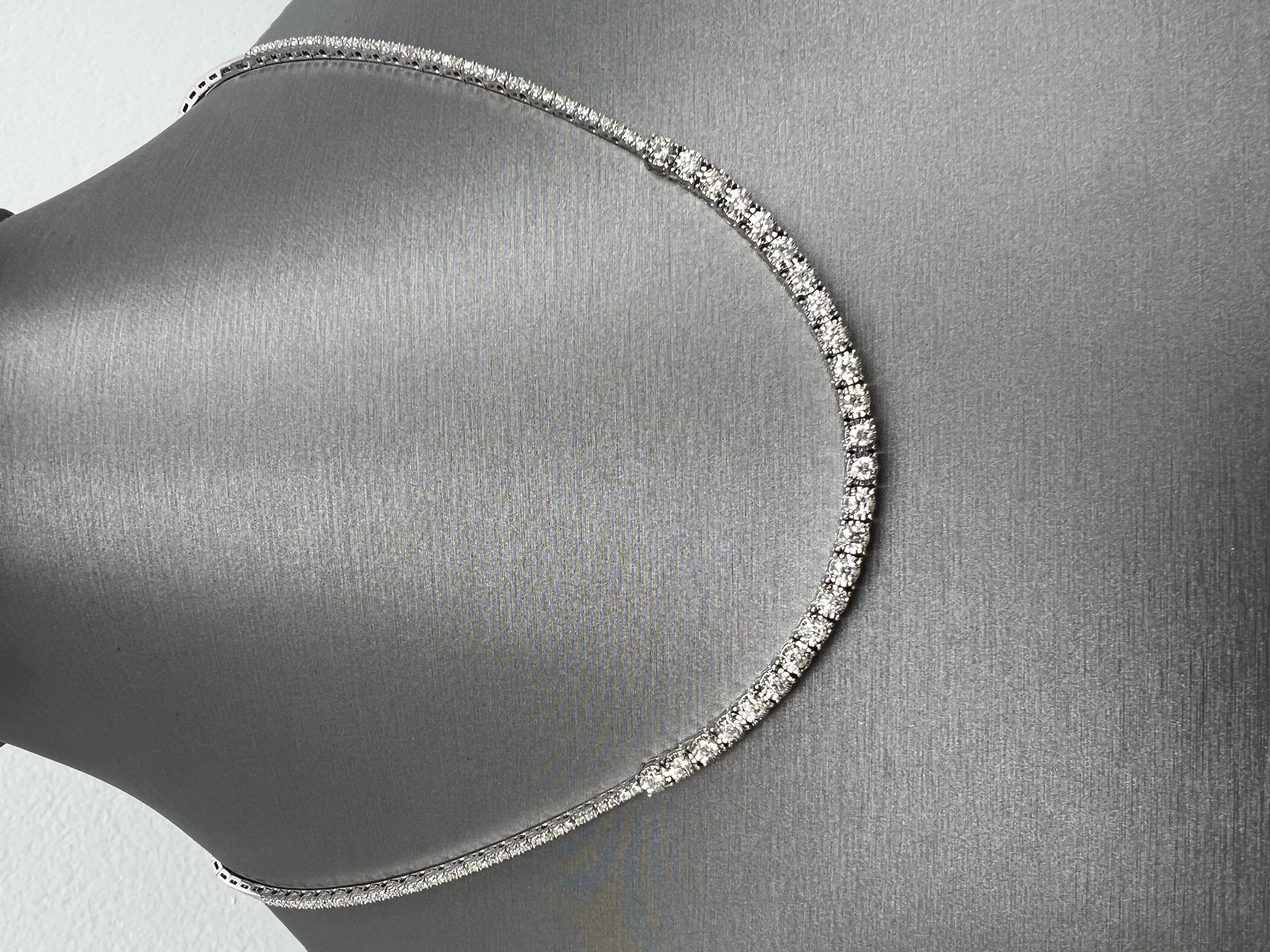 Step into the world of enchantment with this awe-inspiring 14k white gold diamond necklace, a masterpiece that exudes a timeless allure. The necklace boasts a mesmerizing arrangement of natural, full brilliant-cut diamonds, expertly set in two