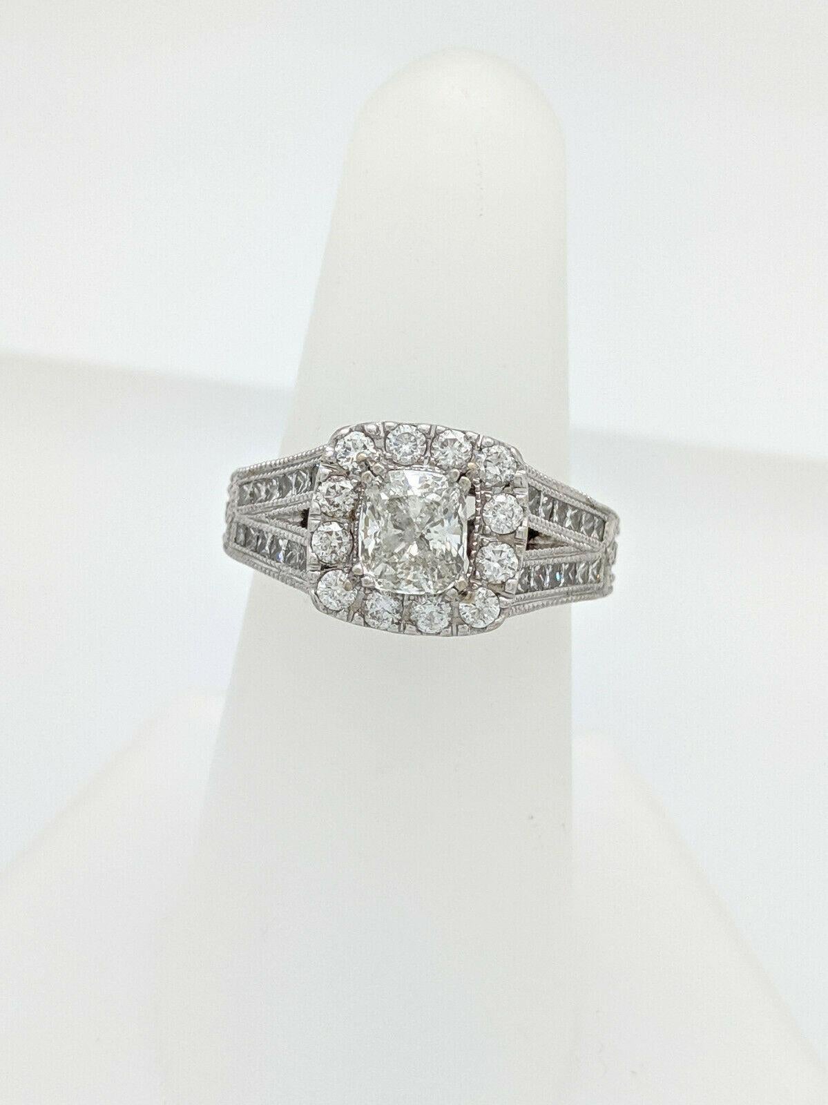 You are viewing a beautiful diamond engagement ring by Neil Lane from the vintage hollywood collection. 
The ring features a 1ct cushion cut diamond as the center which is  beautifully displayed in a 14k white gold setting with round and princess
