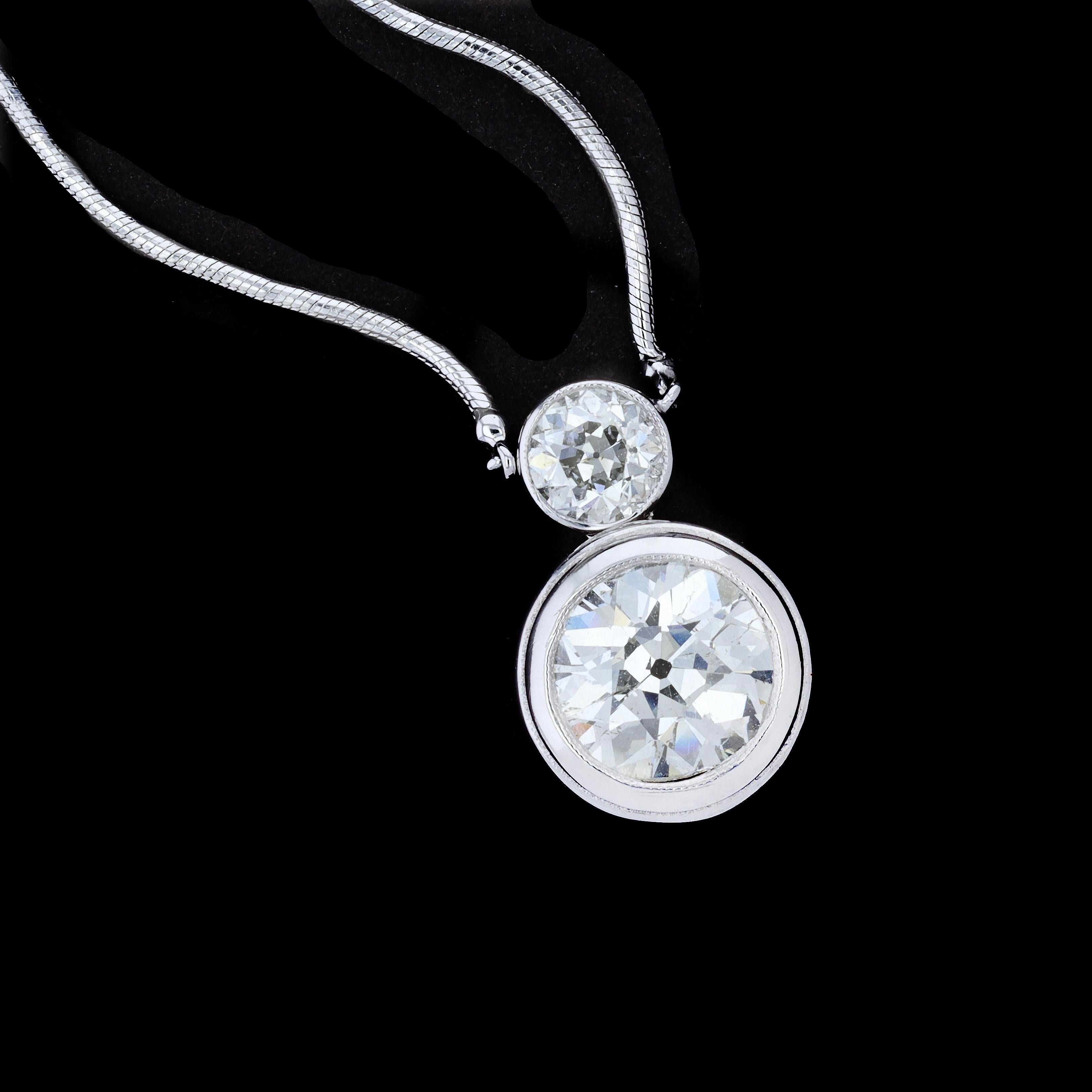 This 14K white gold pendant features 2 Old Mine Cut Diamonds that weigh approximately 17.1ct and 0.35ct. The approximate Color and Clarity of the diamonds is G and SI2 and g and VS2 respectively. 

The pendant measures 15.5mm by 10m and is on a 14K