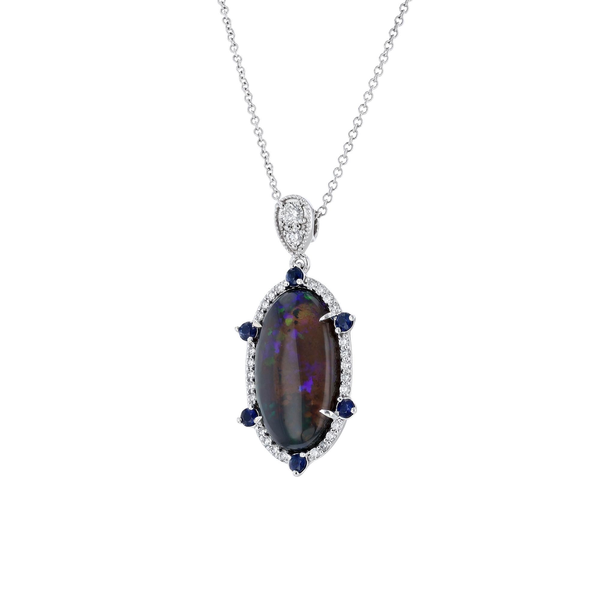 This necklace is made in 14K white gold and features an oval shaped opal weighing 9.20 carats. With a halo and enhancer of 28 diamonds weighing 0.39 carat. Accented with 6 blue sapphires weighing 0.35 carats.  Necklace has a color grade (G) and (H).