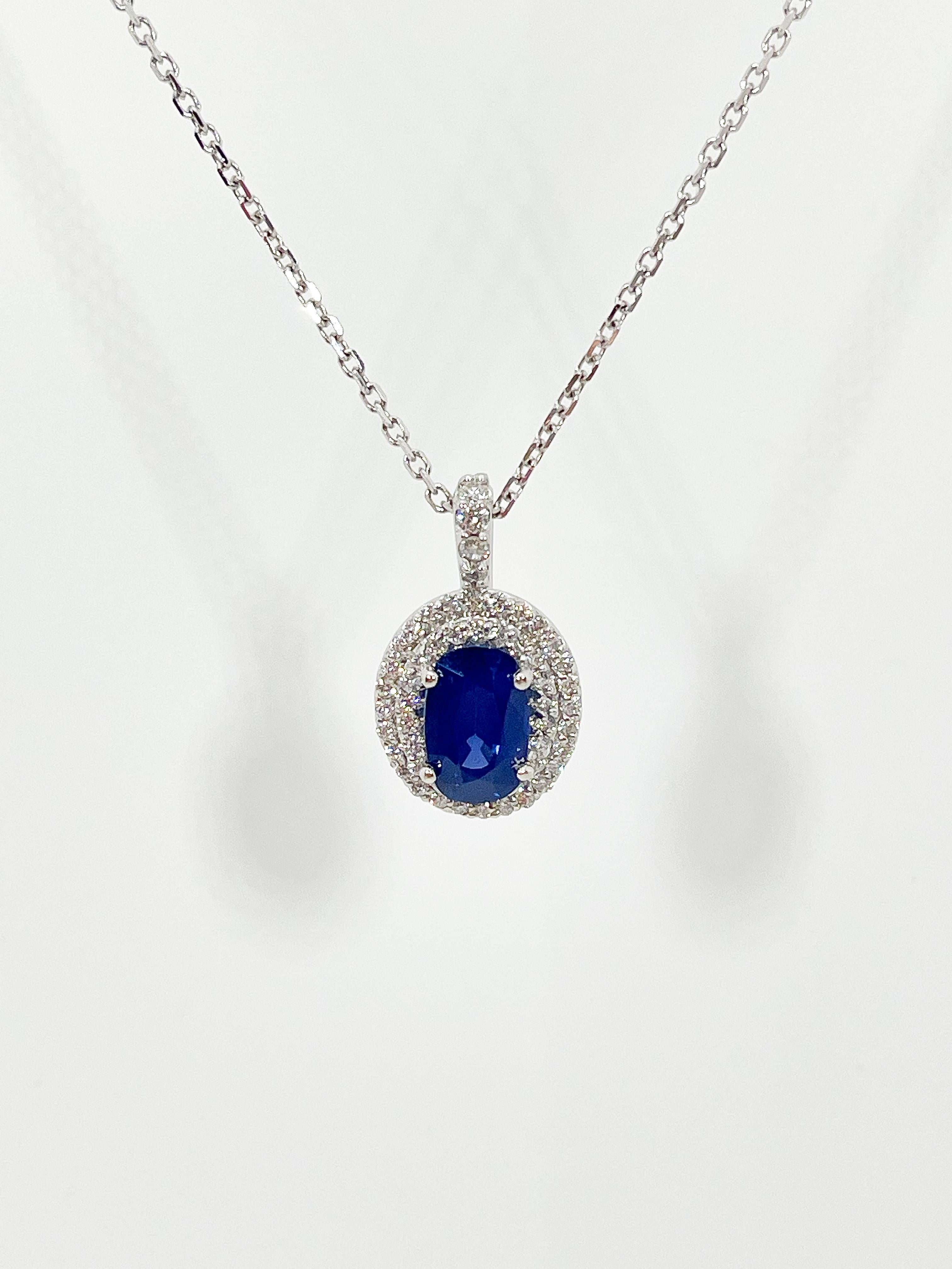 Oval Cut 14K White Gold Oval 2 CT Sapphire and .75 CTW Diamond Halo Pendant Necklace For Sale