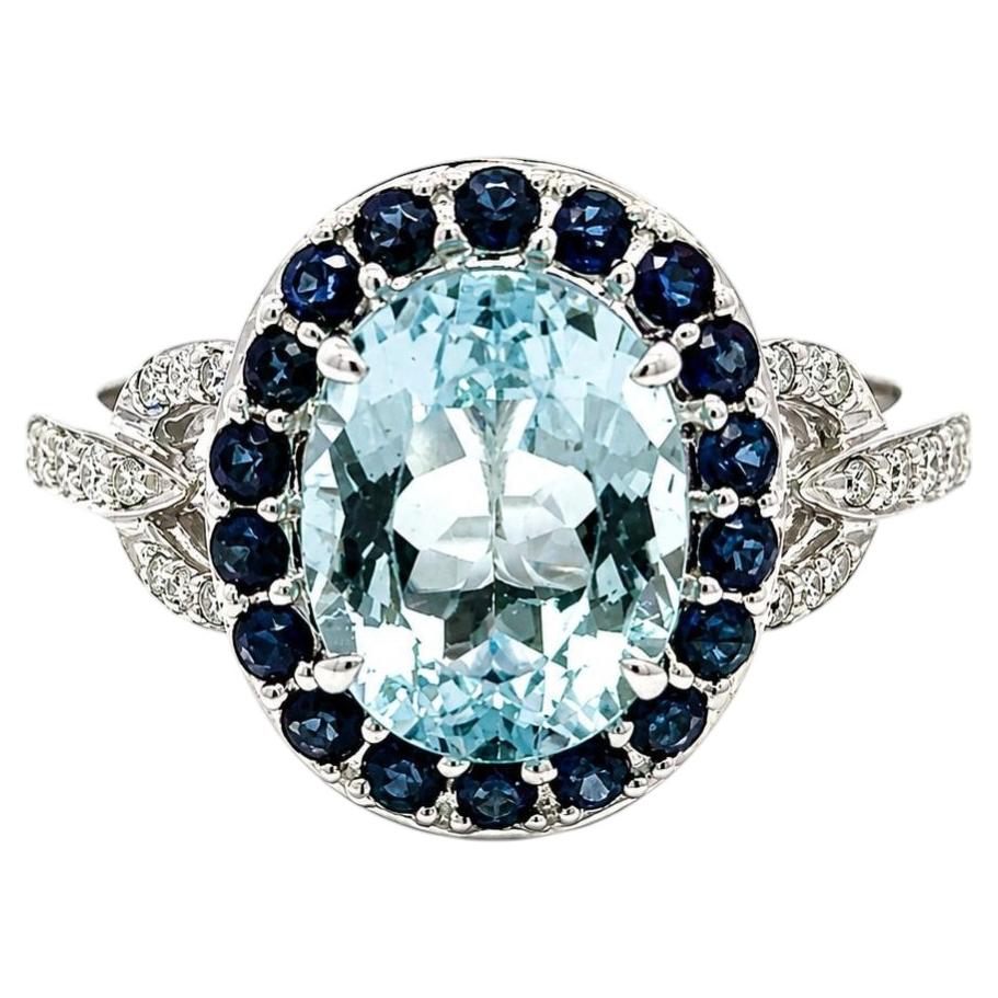 14k White Gold Oval Aquamarine w/ Sapphire Halo & Diamond Buckle Sides Ring