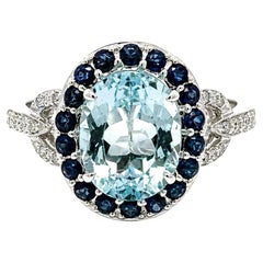 14k White Gold Oval Aquamarine w/ Sapphire Halo & Diamond Buckle Sides Ring