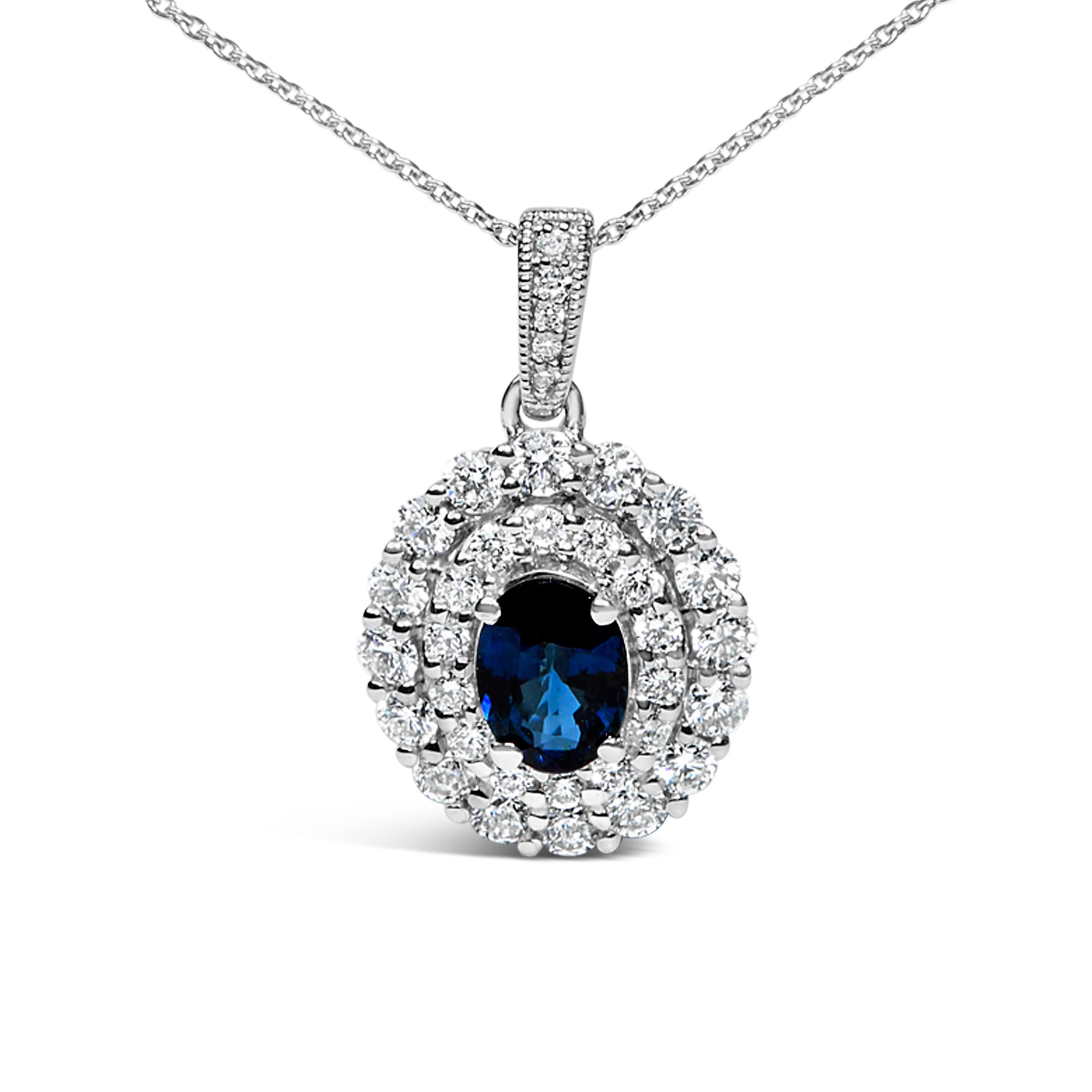 Step into a world of elegance with this exquisite pendant necklace, where a mesmerizing 7x5mm natural blue sapphire takes center stage, evoking the deep hues of an endless ocean. Encased in a radiant symphony of double halo diamonds, totaling 3/4