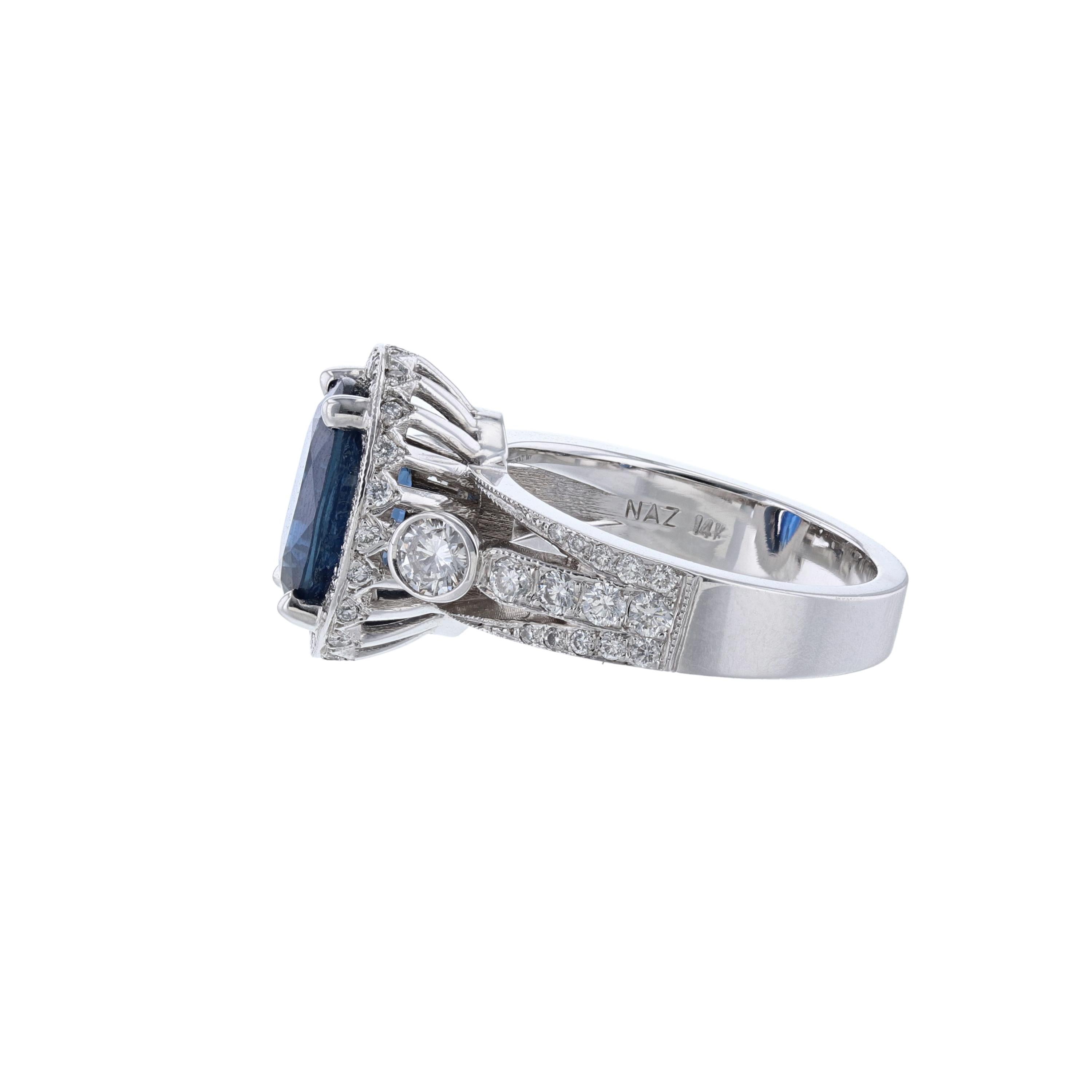 This ring is made in 14k white gold and features 1 oval cut blue sapphire weighing weighing 4.02ct. The ring also features 68 prong set, round cut diamonds weighing 0.98ct. The color grade is (H) with a clarity grade (SI1) 