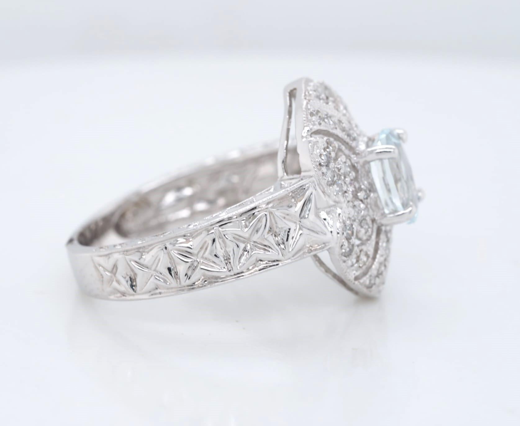 This exquisite ring is crafted from 14k white gold and features an oval cut aquamarine stone as its centerpiece. The aquamarine is complemented by round cut diamonds, creating a stunning display of elegance and sophistication. The ring is perfect