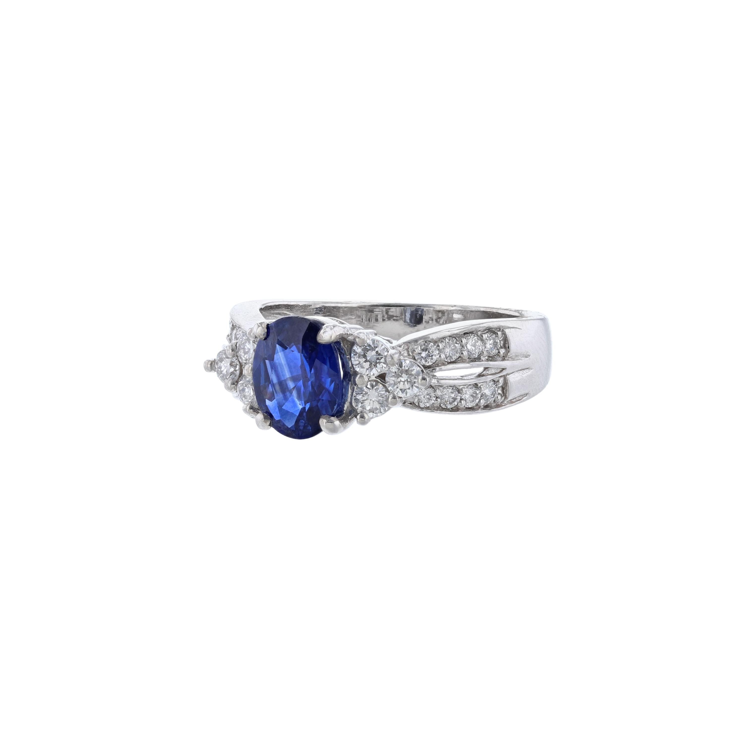 This ring is made in 14K white gold. It features 1 oval cut blue sapphire weighing 1.55 carats and 22 round cut diamonds weighing 0.51 carat. With a color grade (H) and clarity grade (SI2). All stones are prong set.