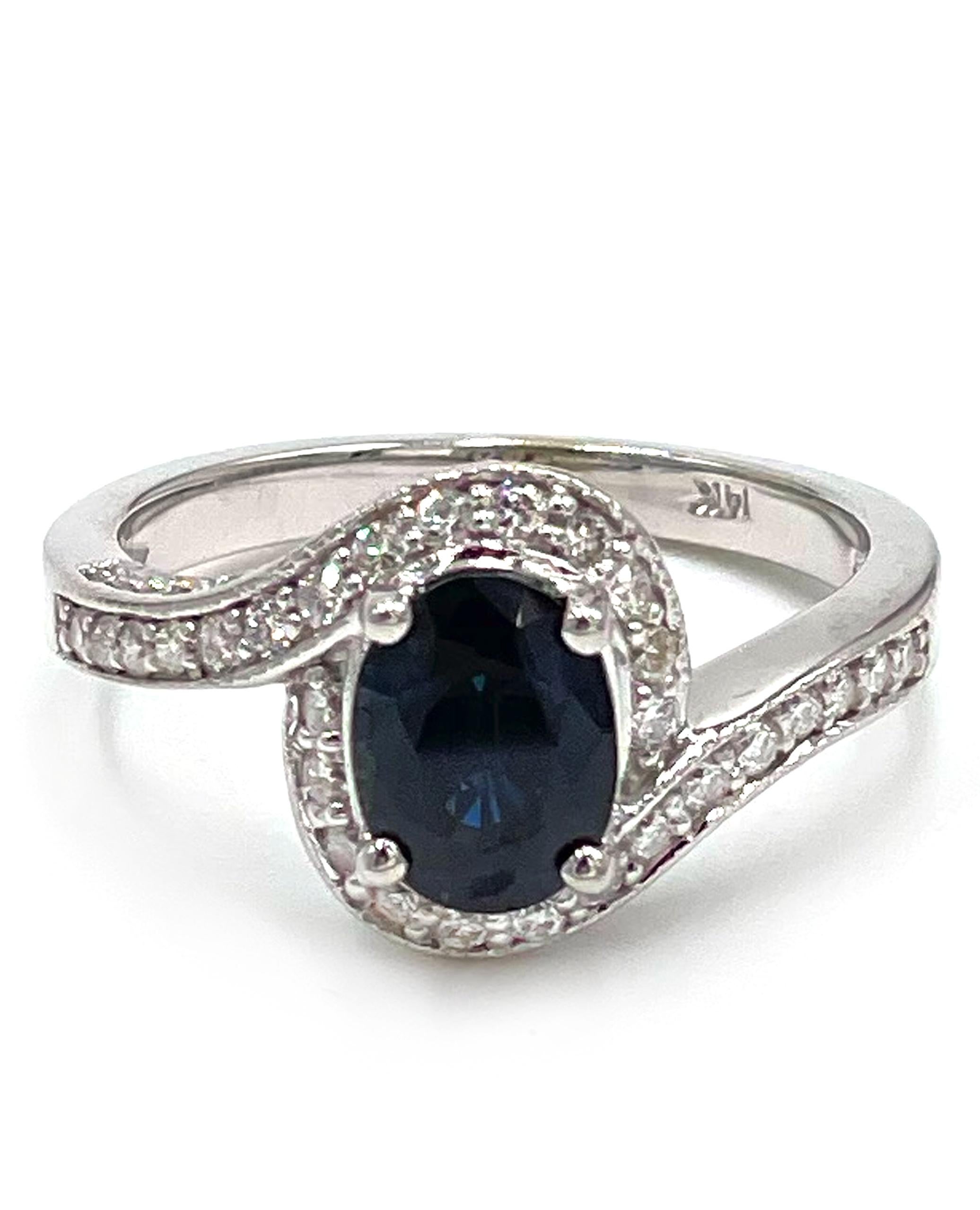 14K white gold right hand ring featuring one oval shape blue sapphire 1.55 carats.  The ring is also furnished with 54 round brilliant-cut diamonds 0.59 carats total weight.

* Diamonds are G color, SI1 clarity.
* Finger size 7