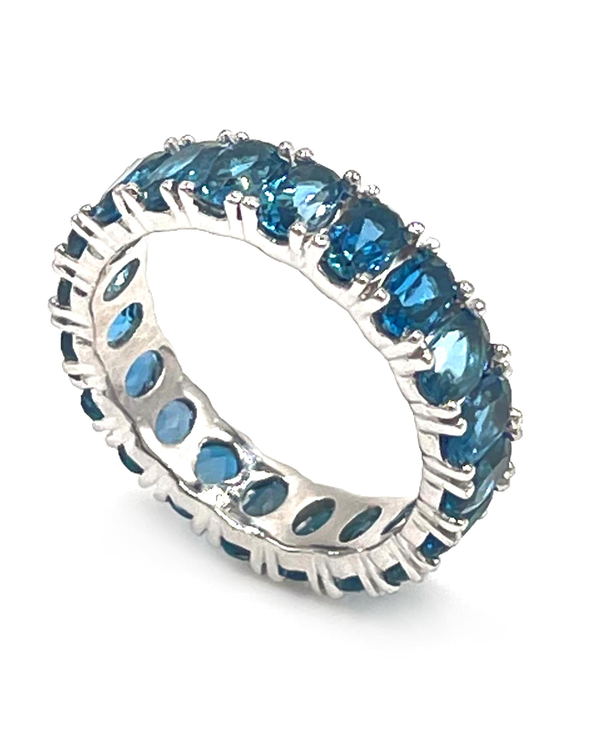 14K white gold eternity ring with prong set oval shape London blue topaz. There are a total of 20 oval shaped London blue topaz weighing 5.29 carats total.

* Finger size 6.75
* Each topaz is approximately 5x3mm
* 5mm wide