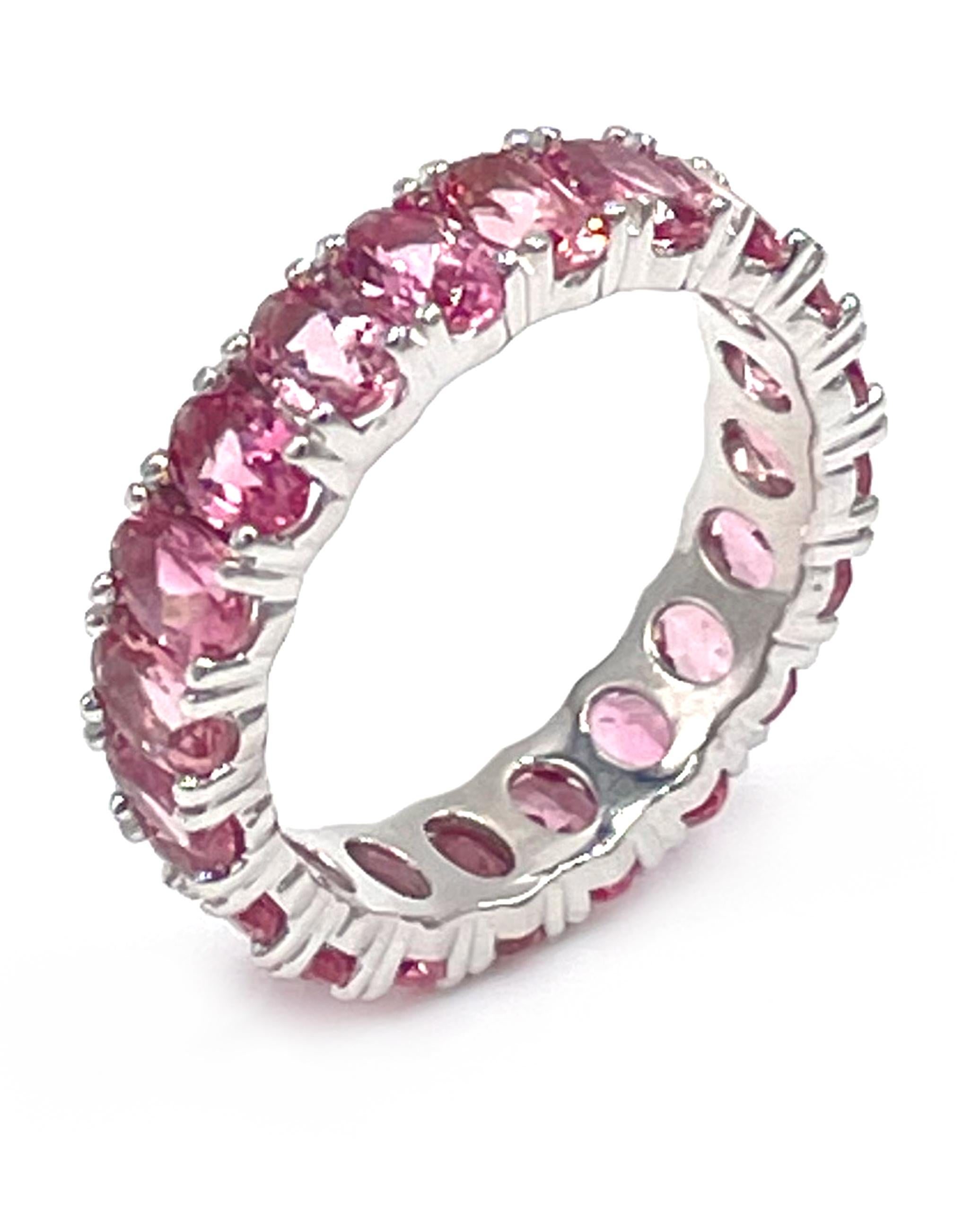 14K white gold eternity ring furnished with 22 oval shaped pink tourmalines weighing 6.60 carats total weight.

* Finger size 6.75 (can be made in any size - 2-3 week turn around)
* 5.00mm wide