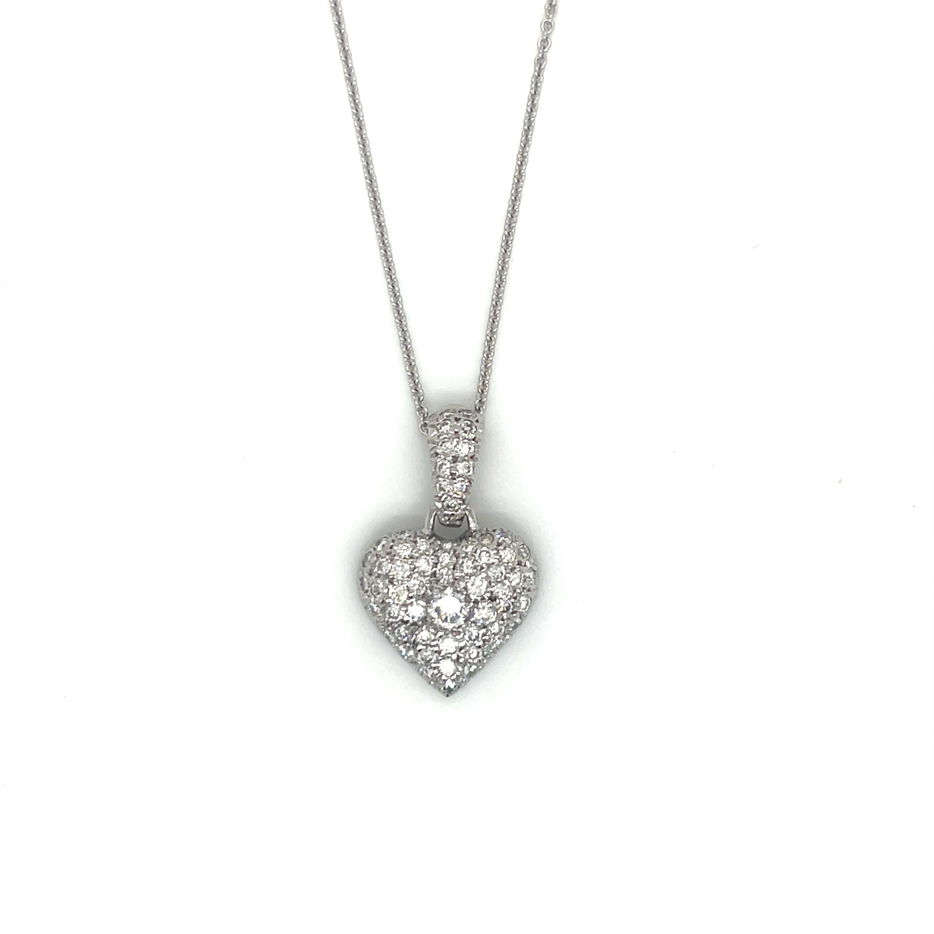 14K White Gold Pave Diamond Heart Pendant Necklace

This elegant 14K white gold pendant features a heart design beautifully set with 1.28 carats of round brilliant diamonds. The piece includes a larger center diamond and a wide diamond-adorned bail