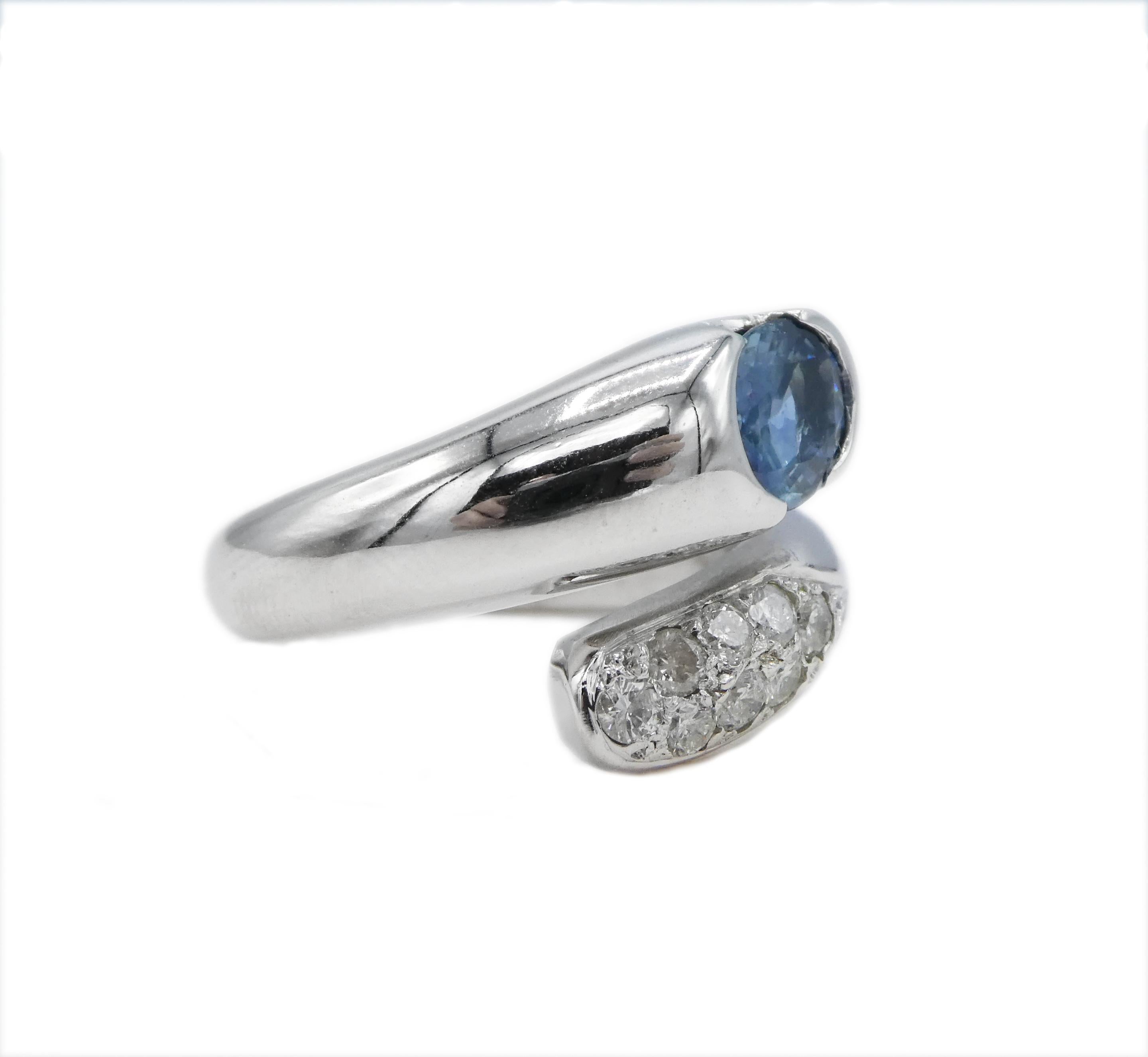Contemporary 14 Karat White Gold Pave Diamond and Oval Blue Sapphire Bypass Cocktail Ring