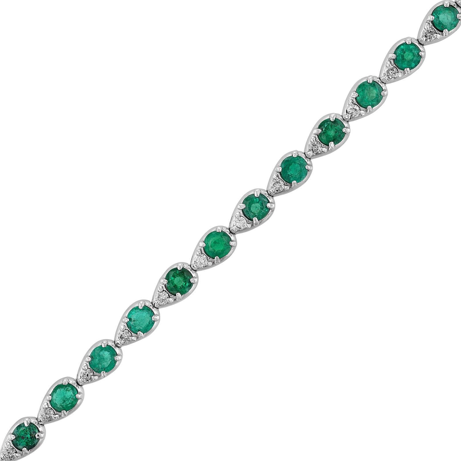 This bracelet is made in 14K white gold. It features 31 round cut emeralds weighing 3.23 carat. Along with 31 round cut diamonds weighing 0.40 carats. In pear shape bezels. The bracelet has a color grade of (H) and a clarity grade (SI2).